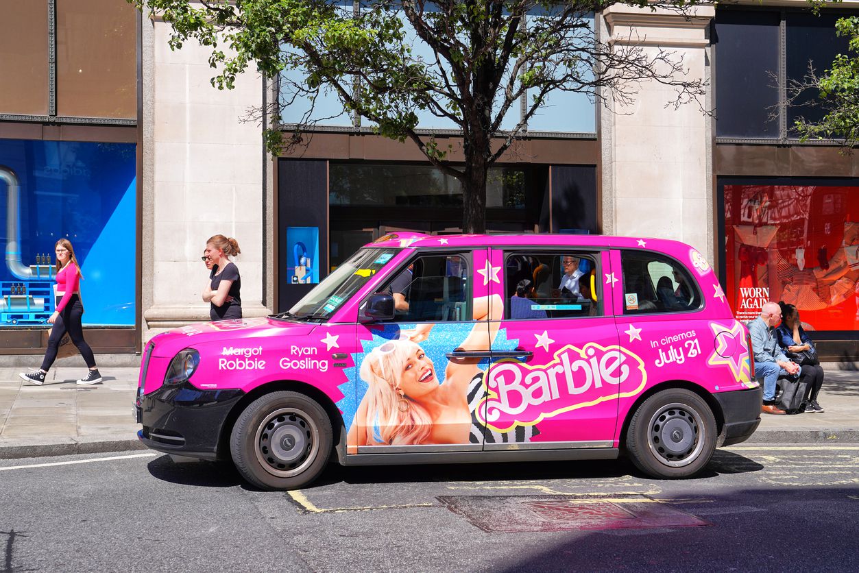 A general view of a London black cab decorated with advertising for the Barbie movie on Oxford Street in Central London, England, UK in August 2023