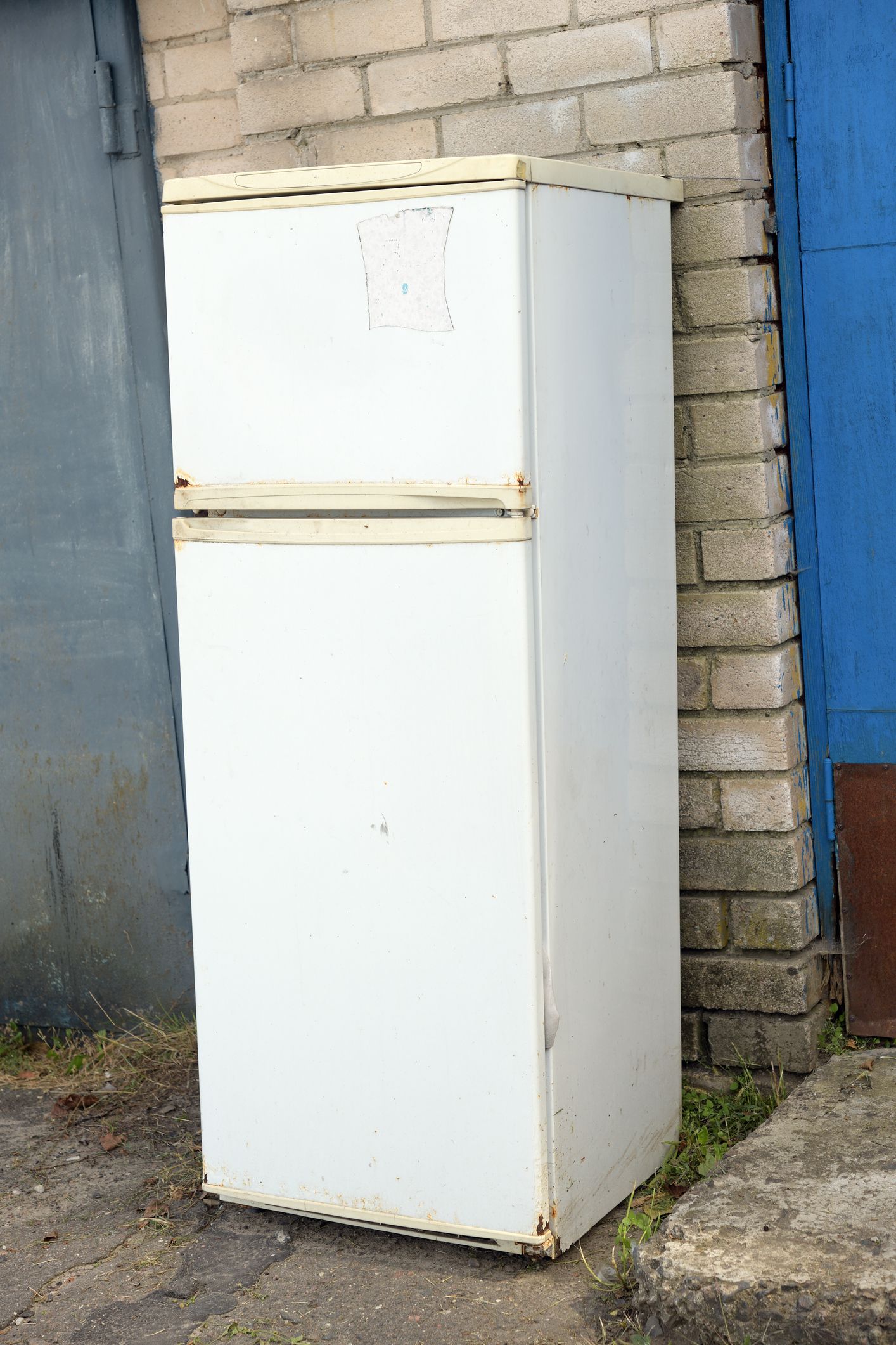 An old refrigerator in a landfill. Ecological problems.