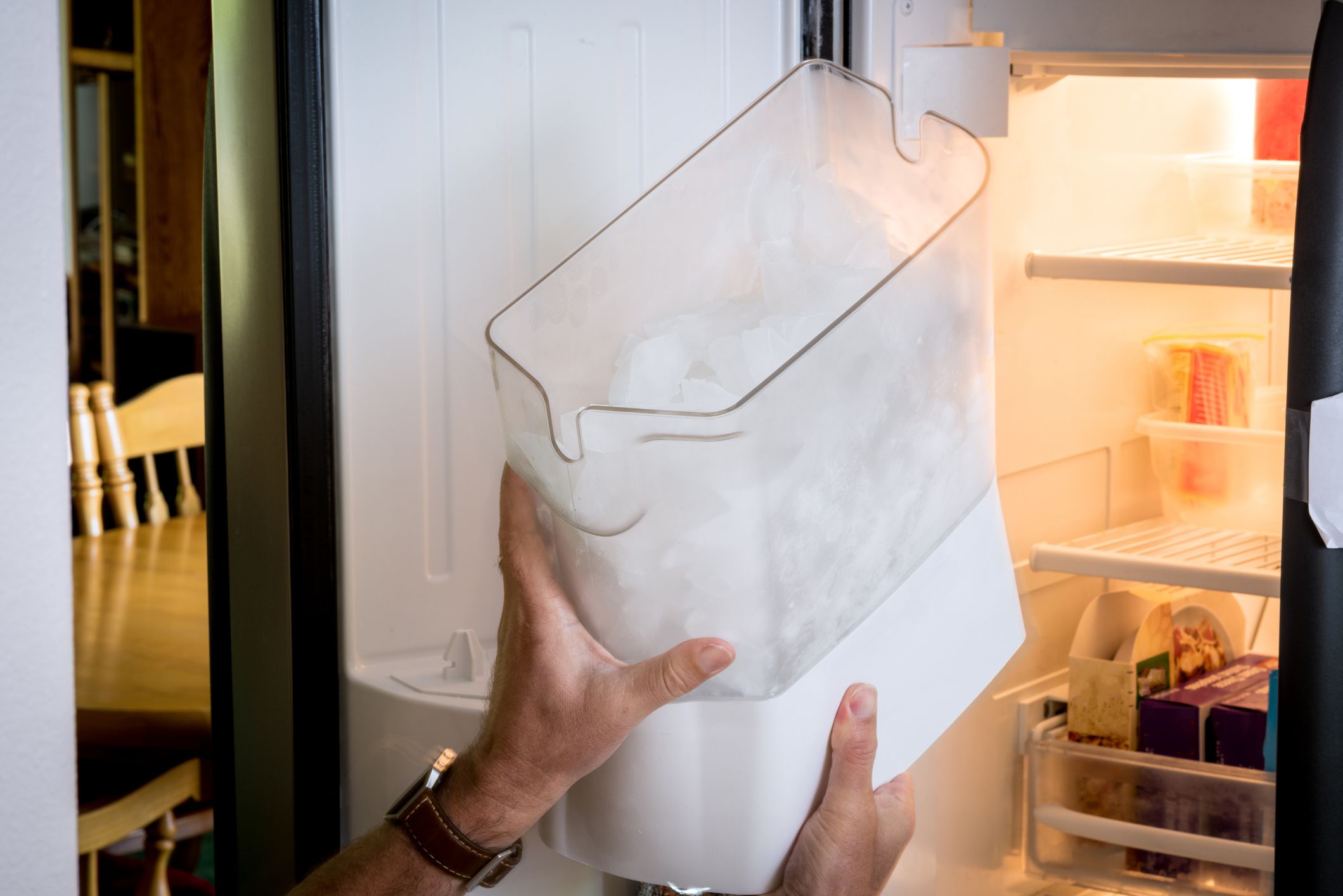 Icemaker remove shown with human hands