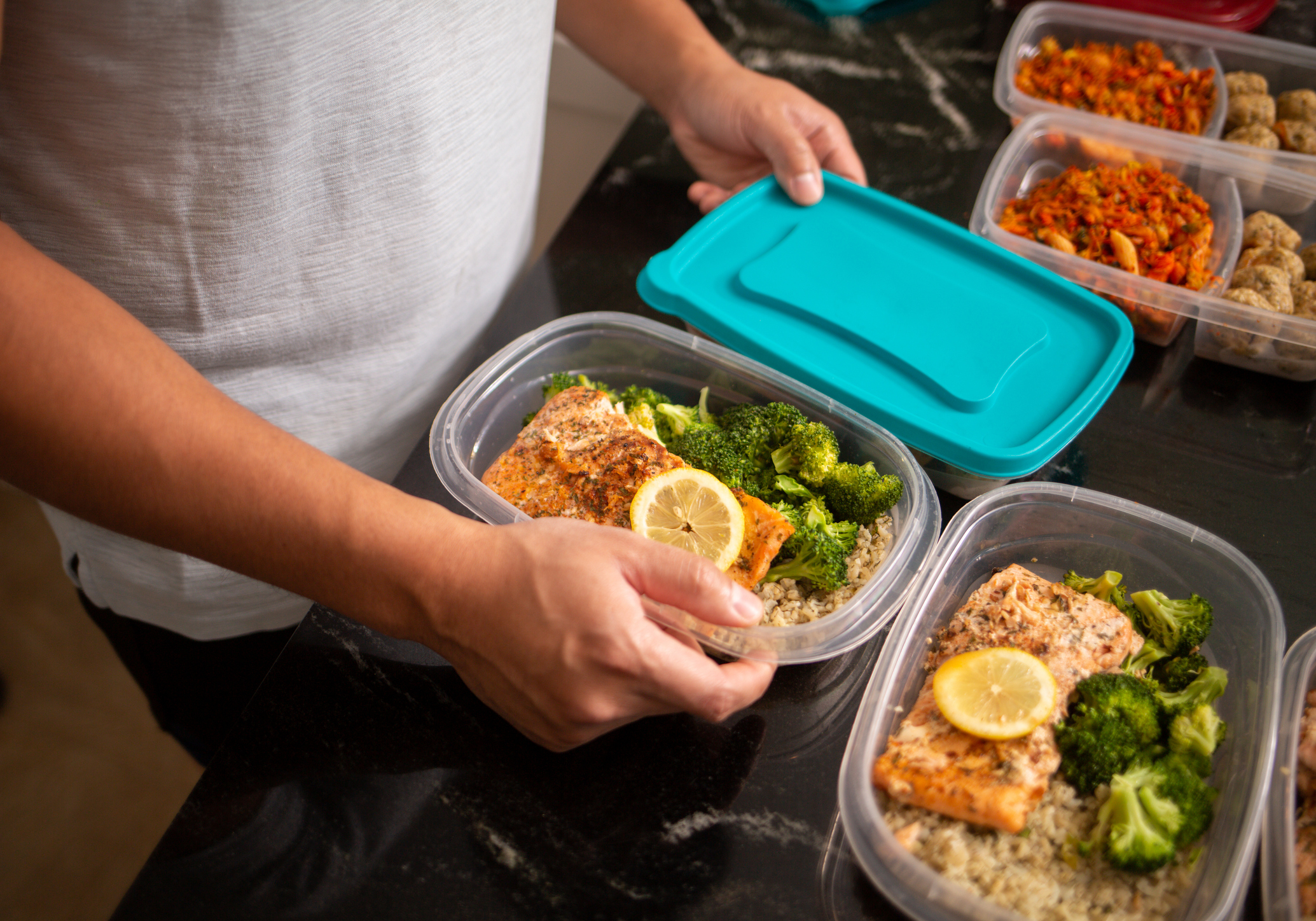 Man Making Meals for Work, Food Portions Into Containers