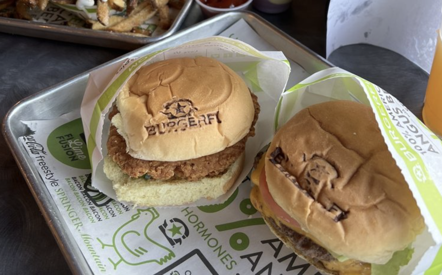 BurgerFi chicken sandwich next to a burger