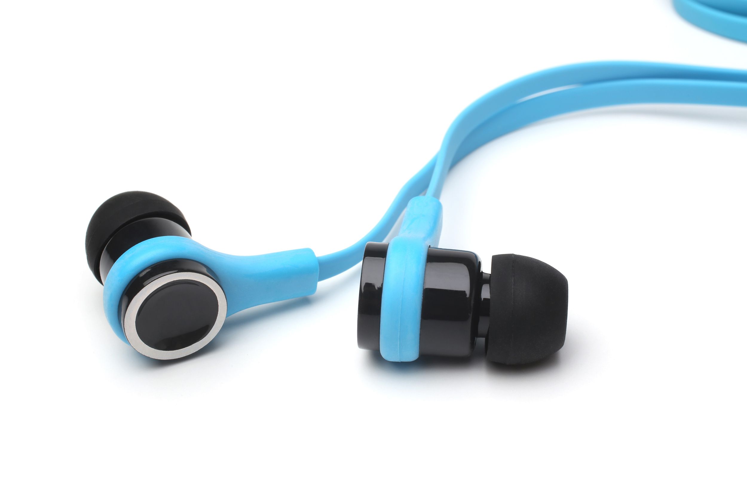 Closeup of blue and black wired earbuds on a white background