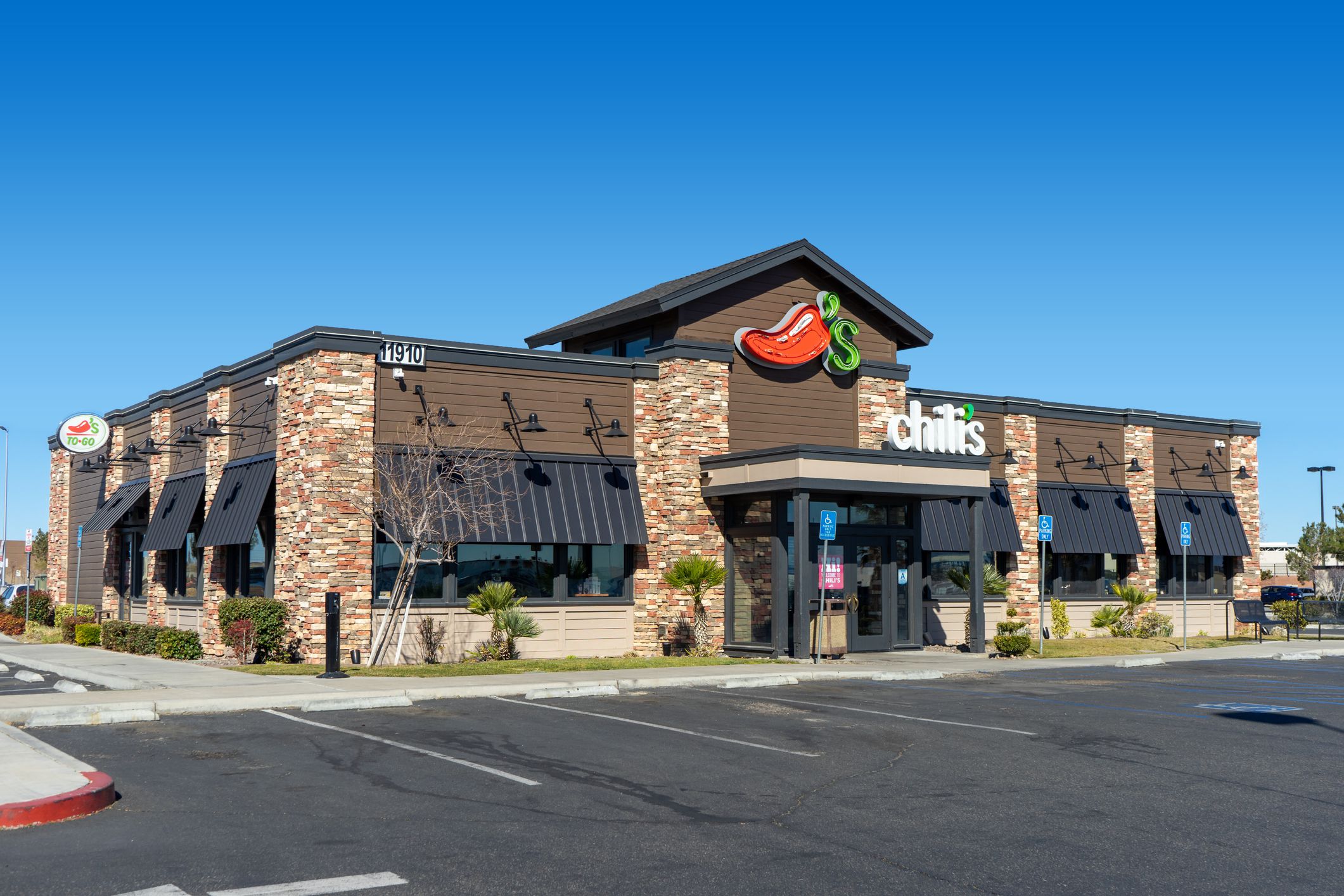 Exterior of Chili's restaurant in Victorville, California with an empty parking lot on a clear, sunny day