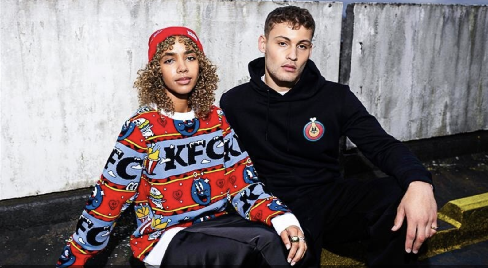 Two teens sitting next to each other on a sofa