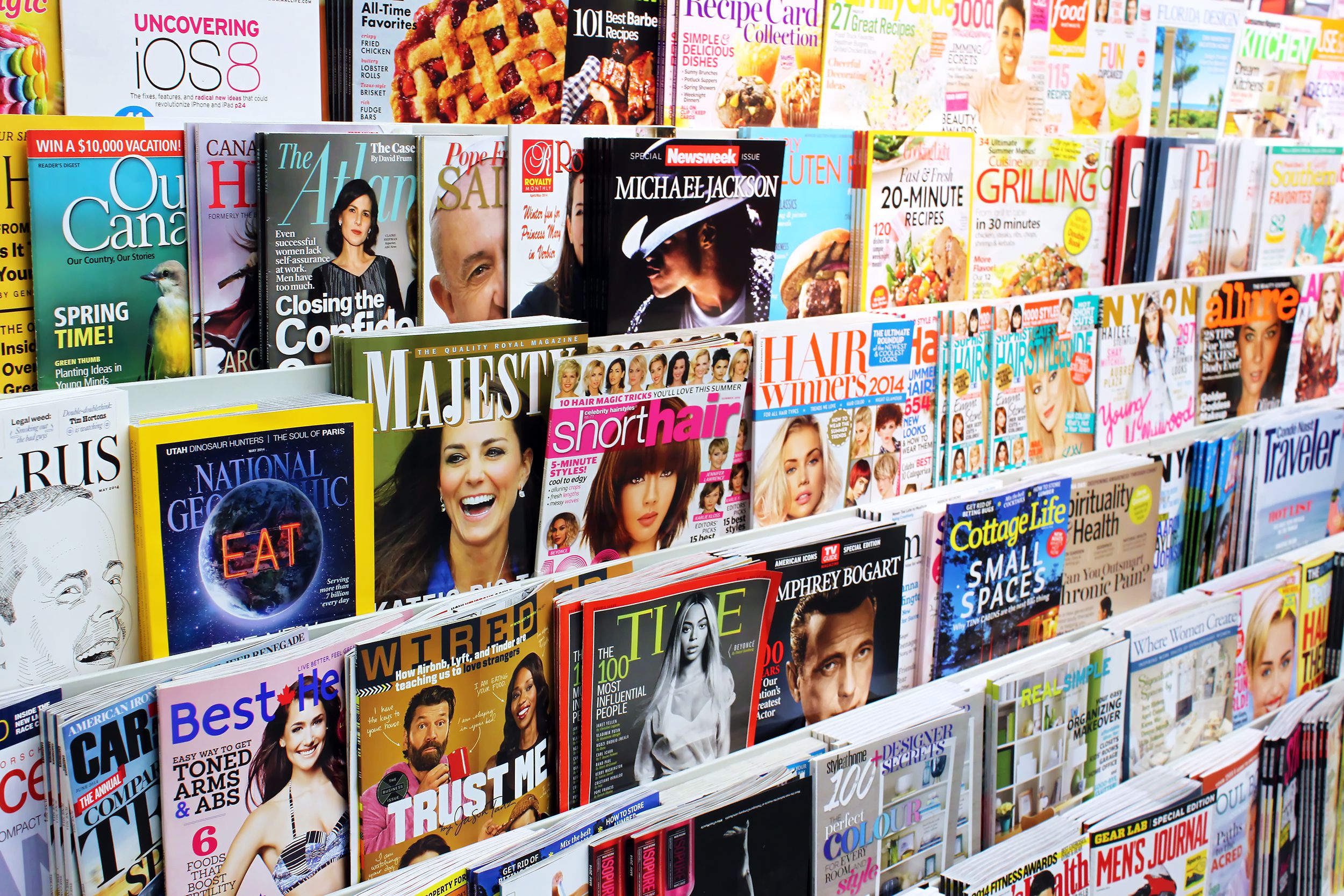 Six rows of colorful magazines for sale at a newsstand