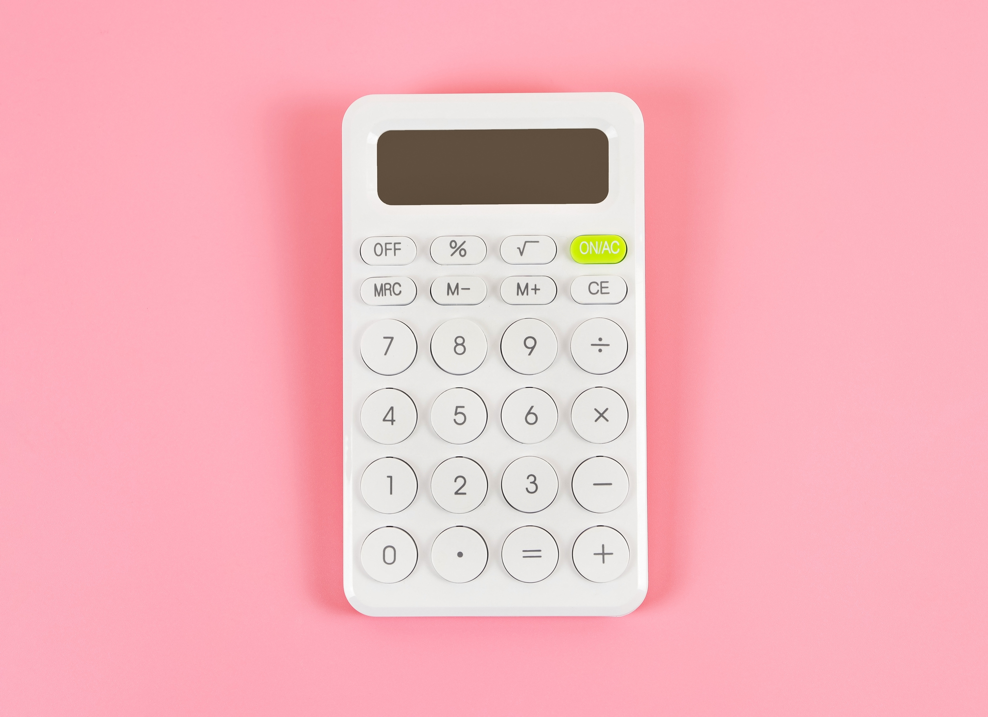 White modern calculator on a pink background
