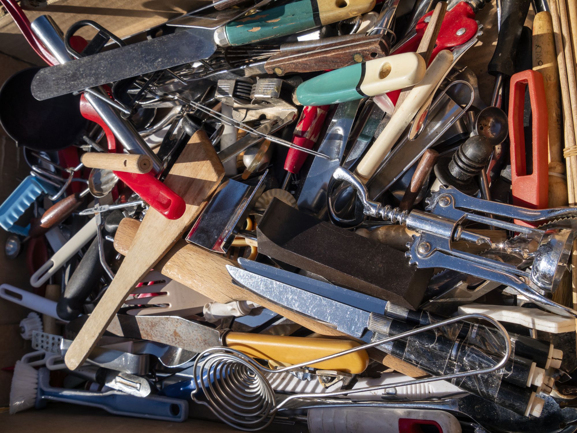 pile of kitchen utensils at a thrift store