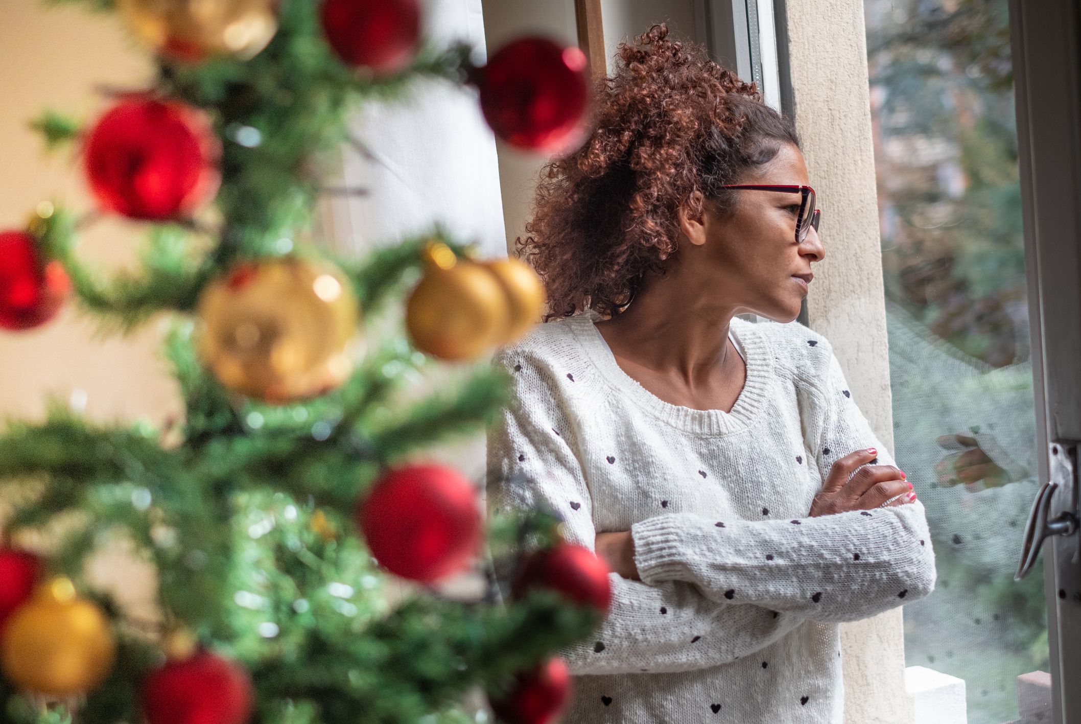 Pensive young black woman celebrating Christmas alone