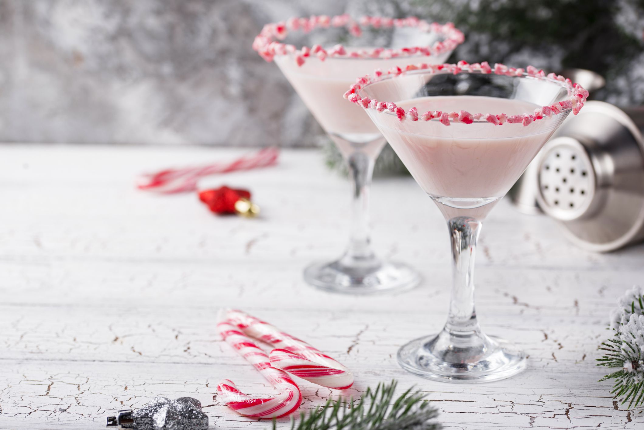 Pink peppermint martini with candy cane rim. Christmas cocktail