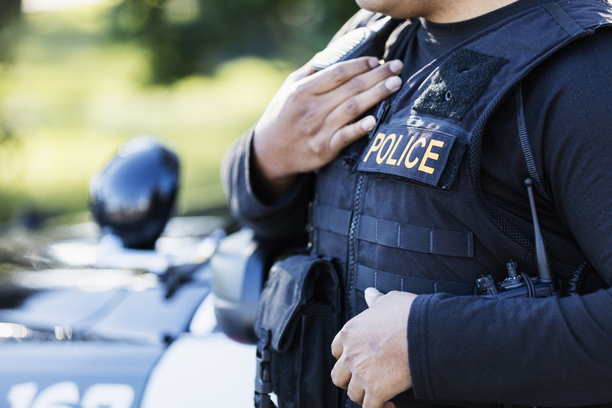 A close-up image of a cop in a protective vest.