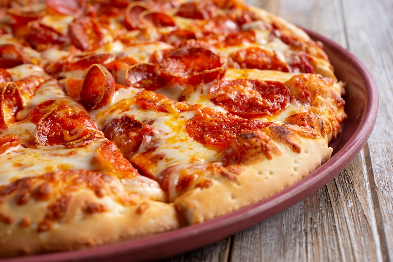 A pepperoni pizza placed on a plate.