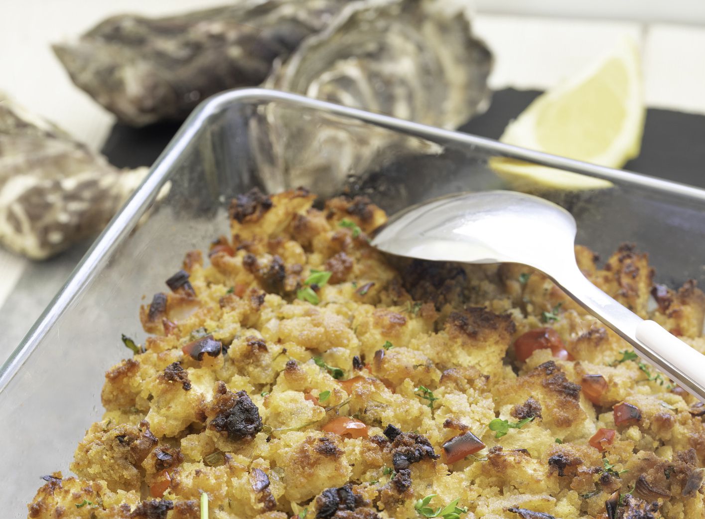 Homemade oyster cornbread stuffing in a Southern-style cornbread dressing made with red bell pepper, celery, onion, herbs, crumble cornbread, cubed white bread and oyster served for a traditional Southern Thanksgiving