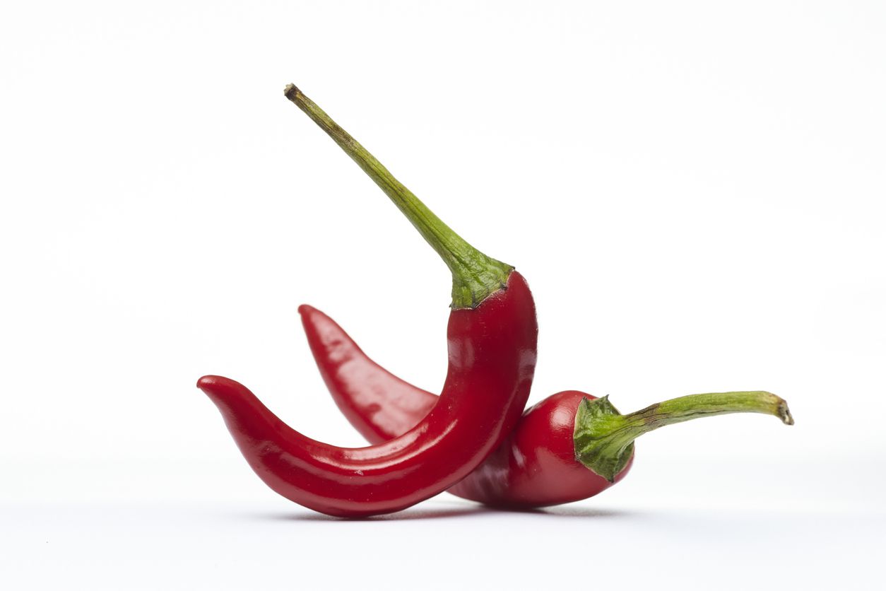 An image of a couple of red-colored peppers.