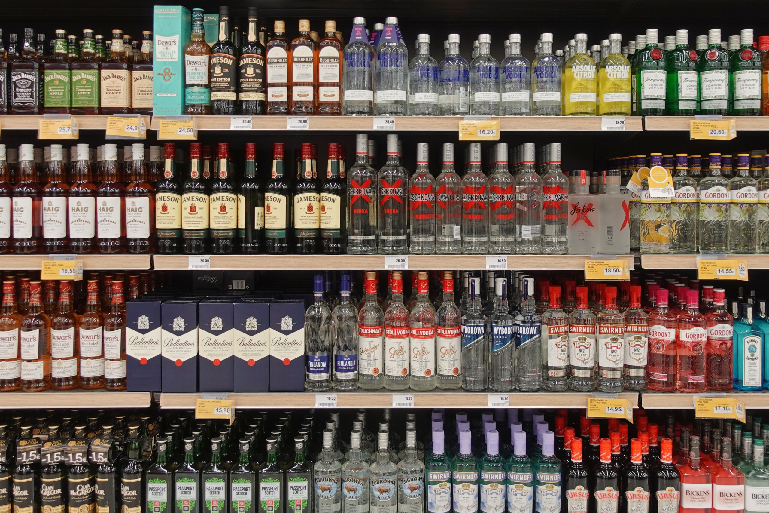Athens, Greece - March 6, 2023: Whisky vodka and gin alcoholic drink beverage bottles on display at liquor store.