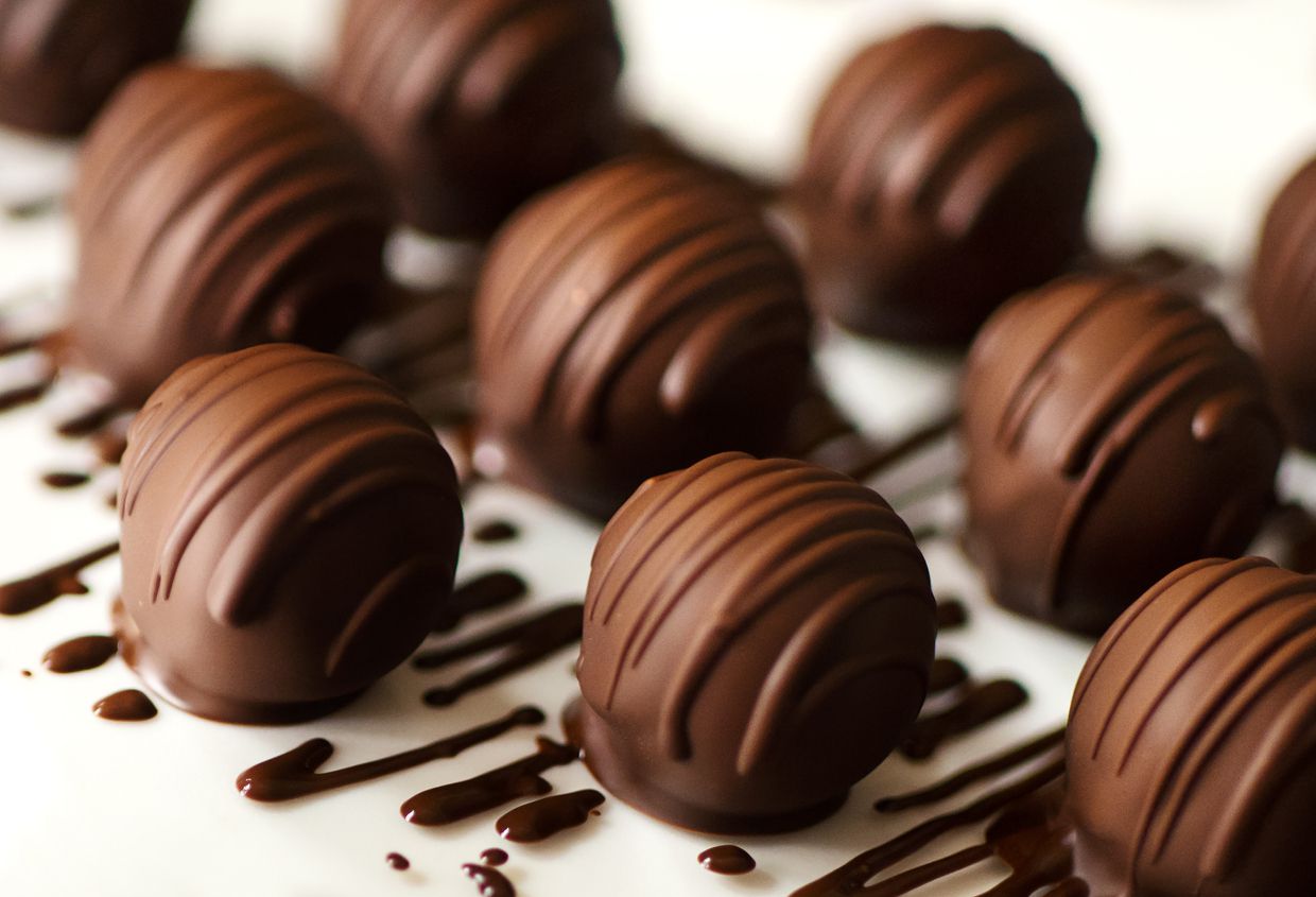 A group of chocolate truffles that have been placed next to each other.