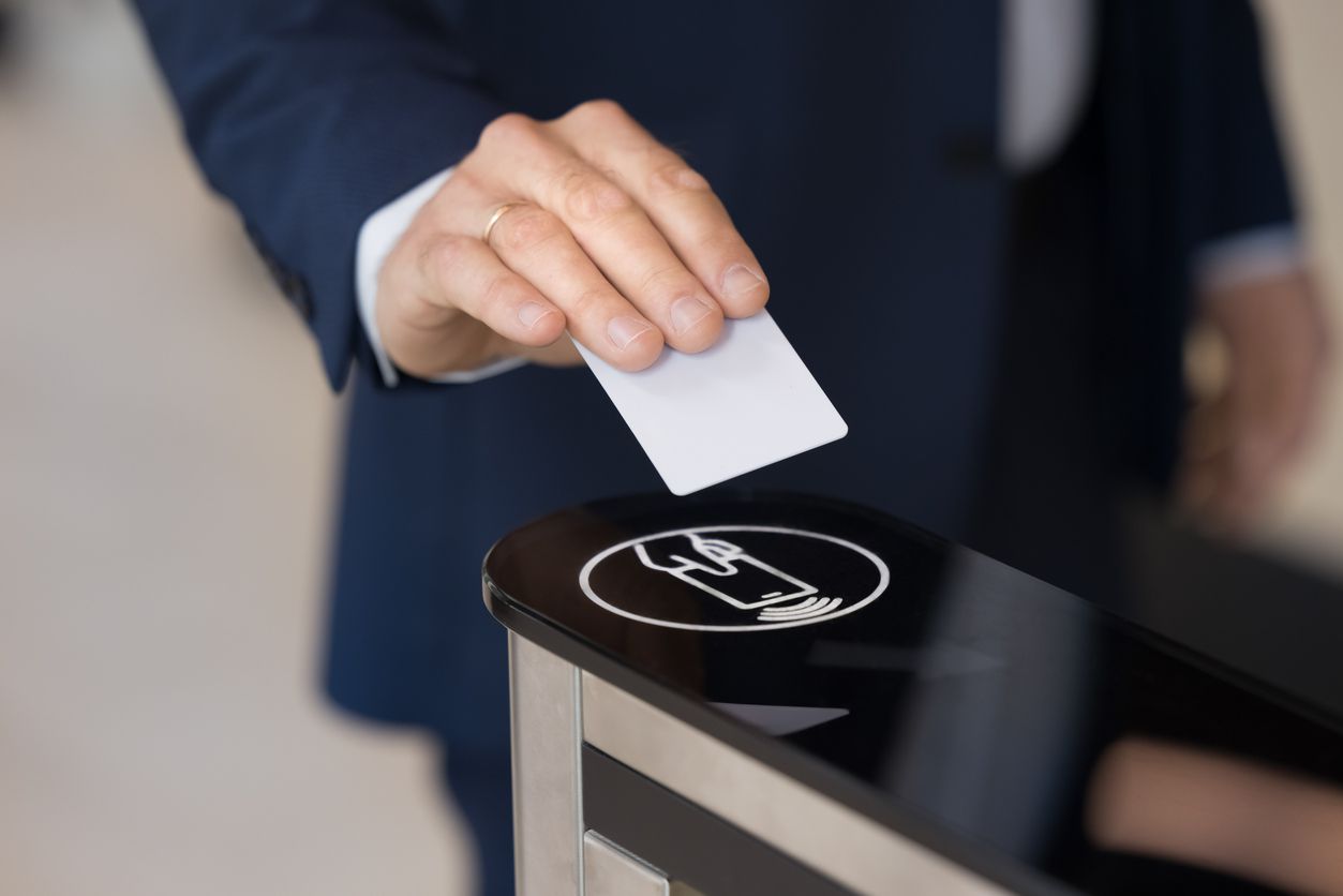 Business man holding electronic keycard at sensor control