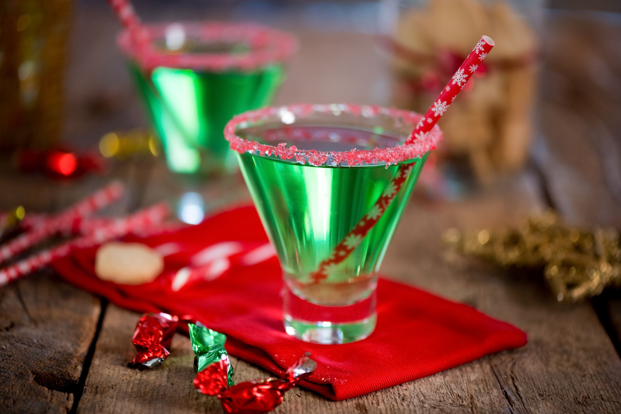 Christmas emerald green cocktail, glass rimmed with crushed candy cane. Great drink for entertaining.