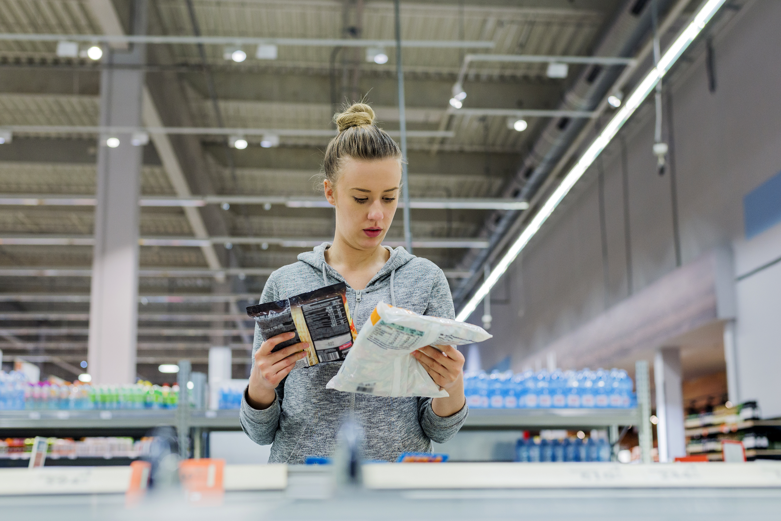 Woman comparing freezer items