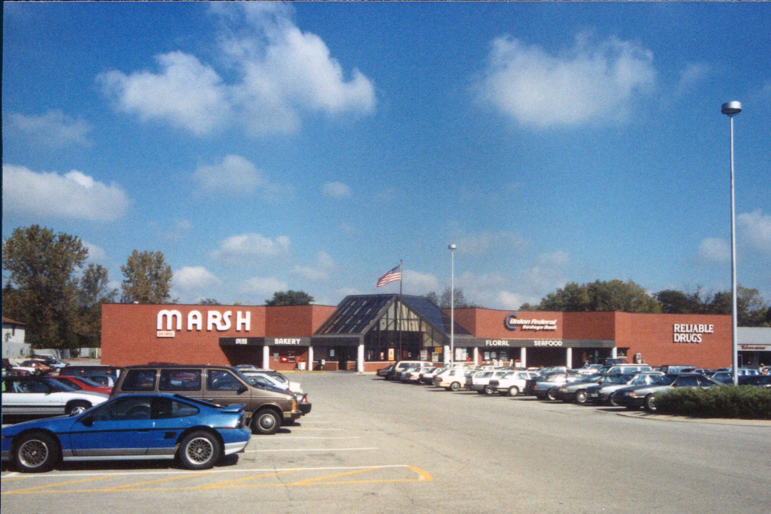 Front exterior of Marsh Supermarket, Indianapolis, circa early 90s, large parking lot with numerous cars in the foreground, on a sunny day during late summer