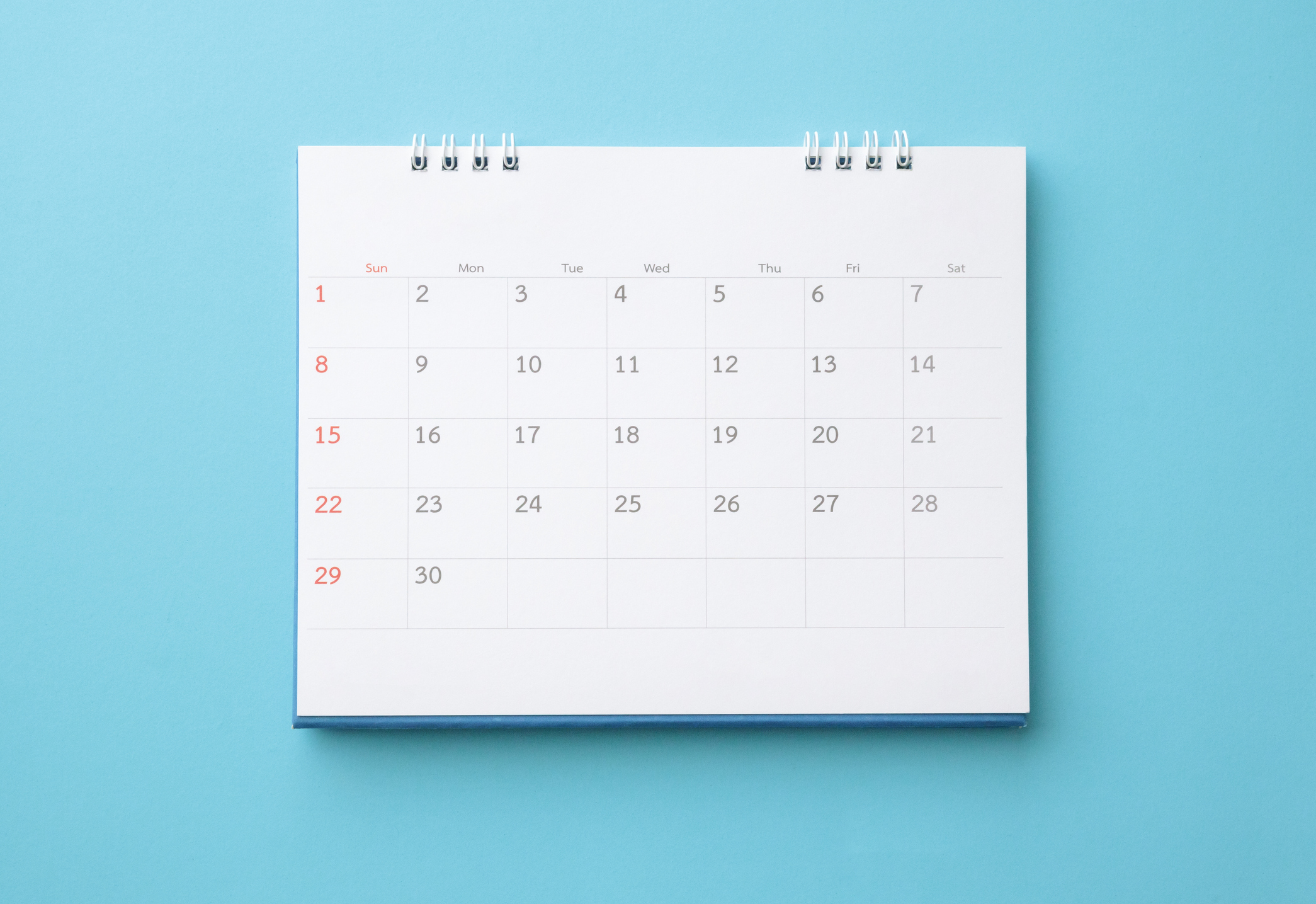 White blank wall calendar on a light blue background