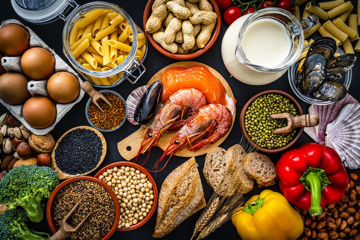 Most common allergens food shot from above. The composition includes fish, crustaceans mussels, peanut, eggs, milk soy products, bee pollen, nuts, wheat and derivates and sesame.