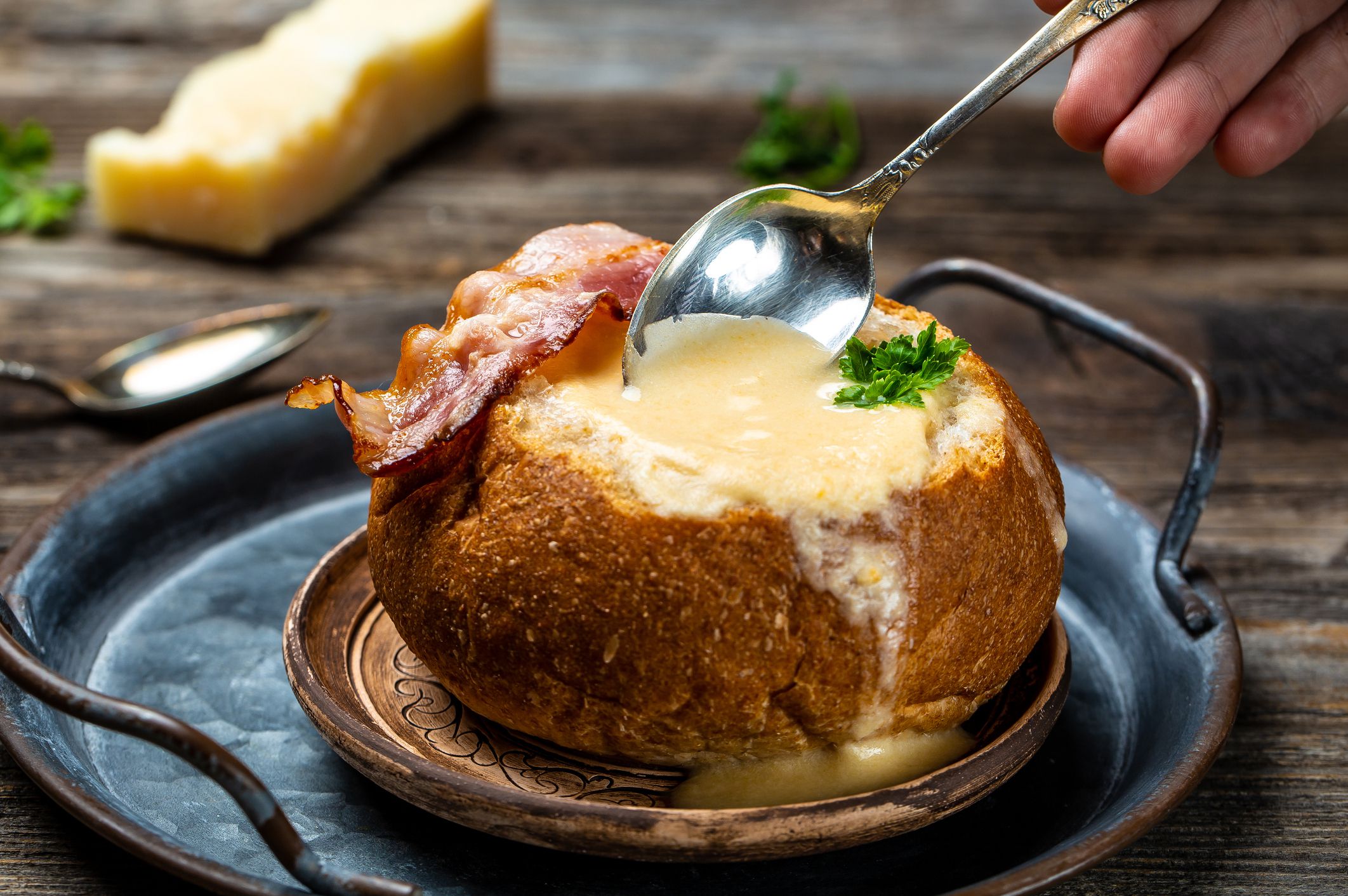 cheese cream soup with potato and bacon on a rustic background. banner, catering menu recipe.