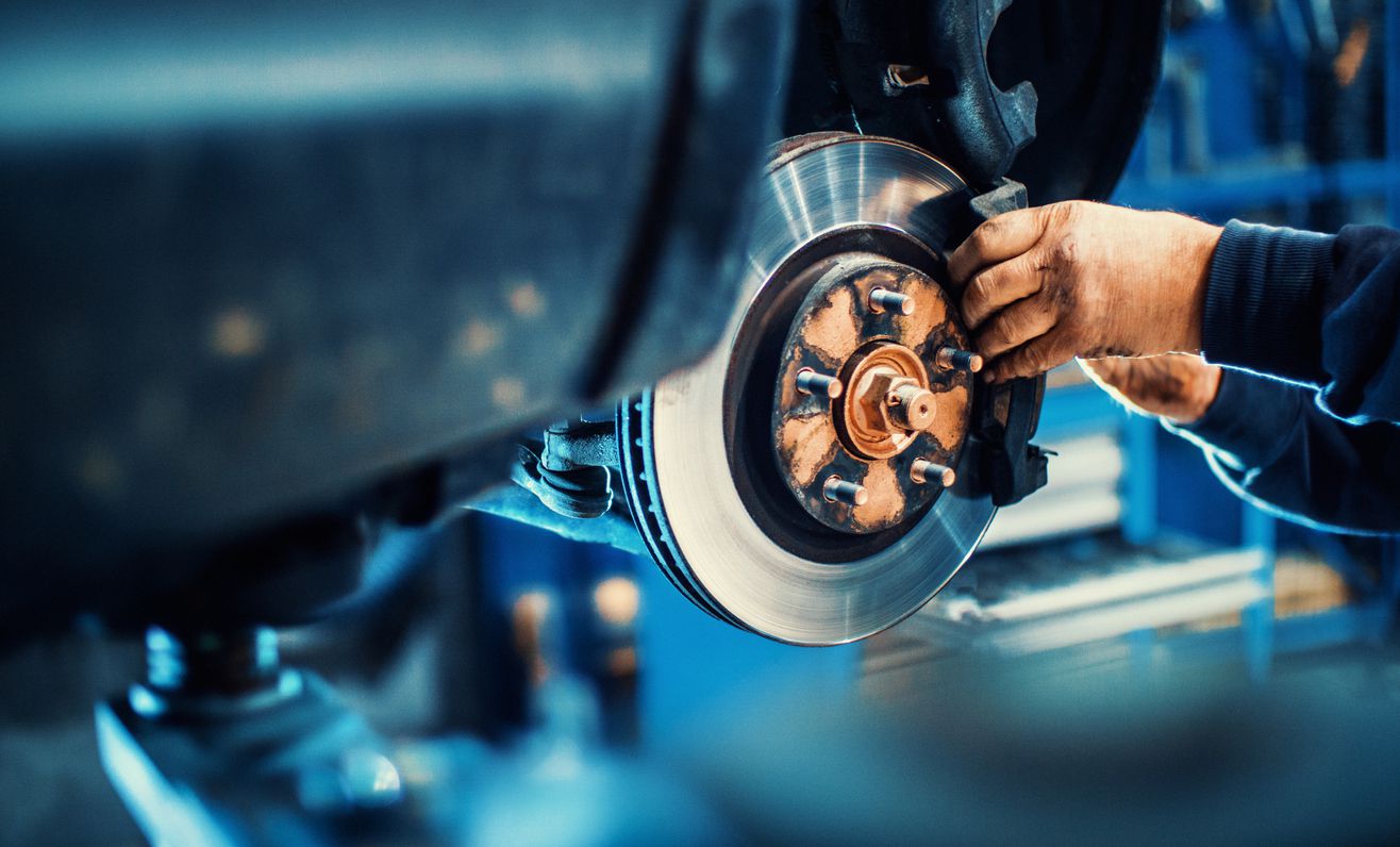 An image of someone repairing a car.