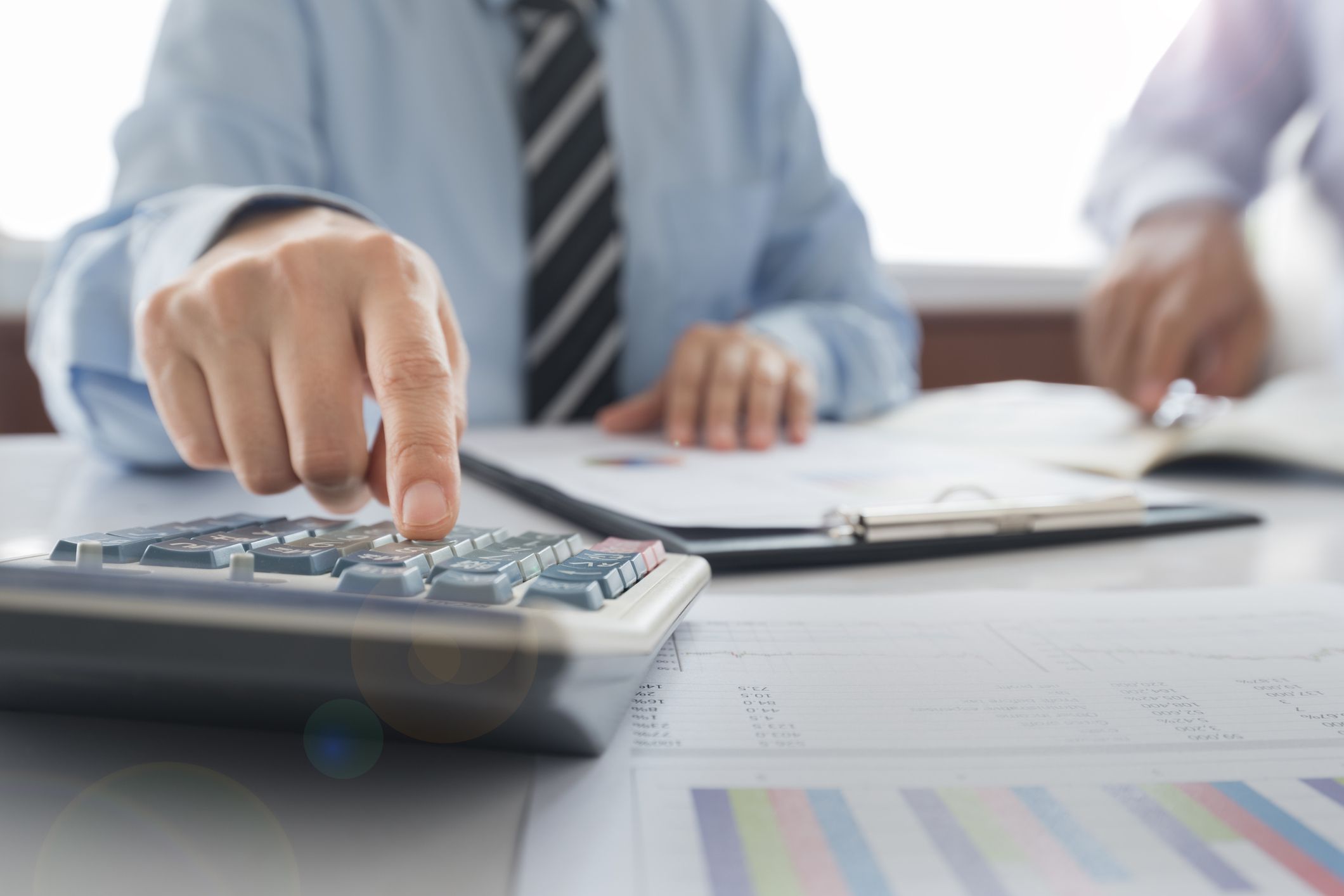 Businessman using a calculator to calculate the numbers. Accounting , Accountancy, Calculation Concept.
