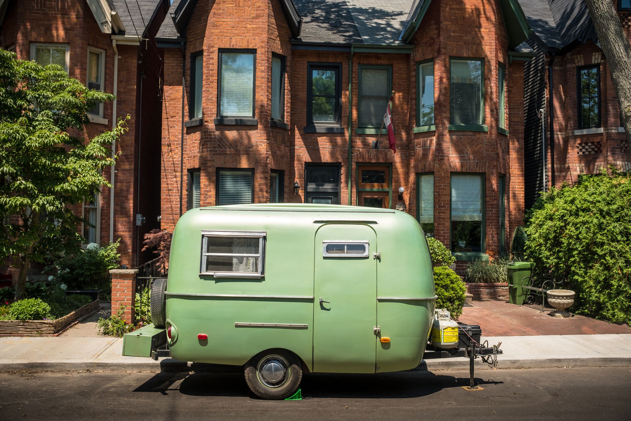 Vintage Camper trailer parked on the urban street of North American City.
