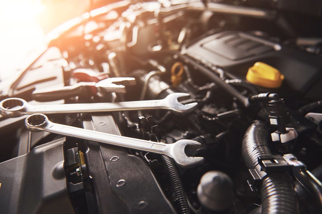 An image of car repair tools with the sun shining in the background.