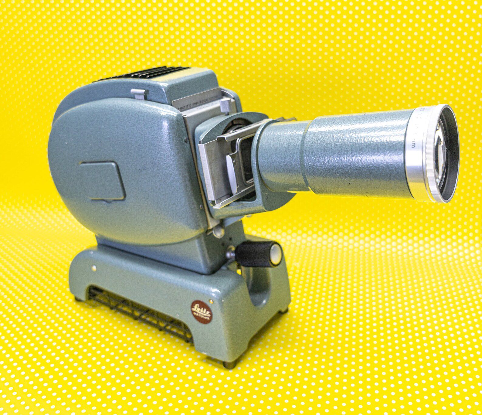 1950s Leica Leitz Prado Slide Projector on a yellow polka dot background
