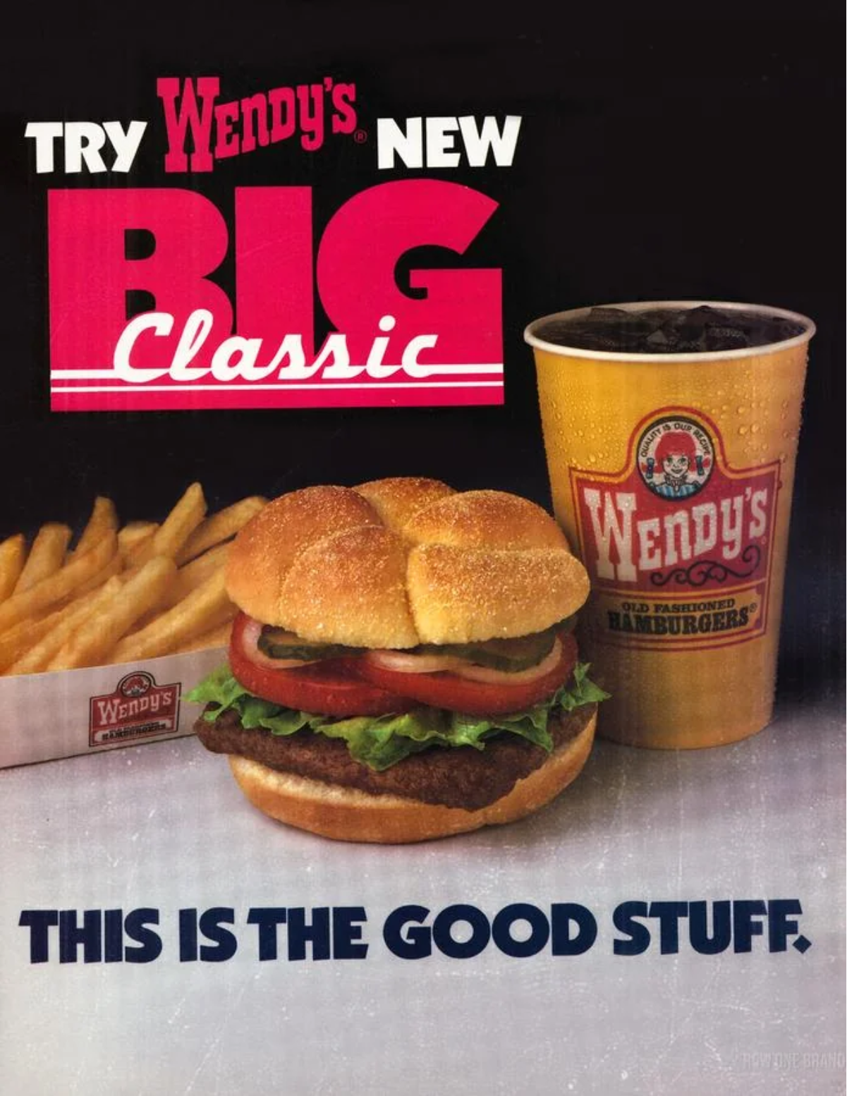 An advertisement for Wendy’s featuring a hamburger with lettuce, tomato, onion, fries, and a soft drink. Bold text reads, “Try Wendy’s New Big Classic—This is the Good Stuff.”