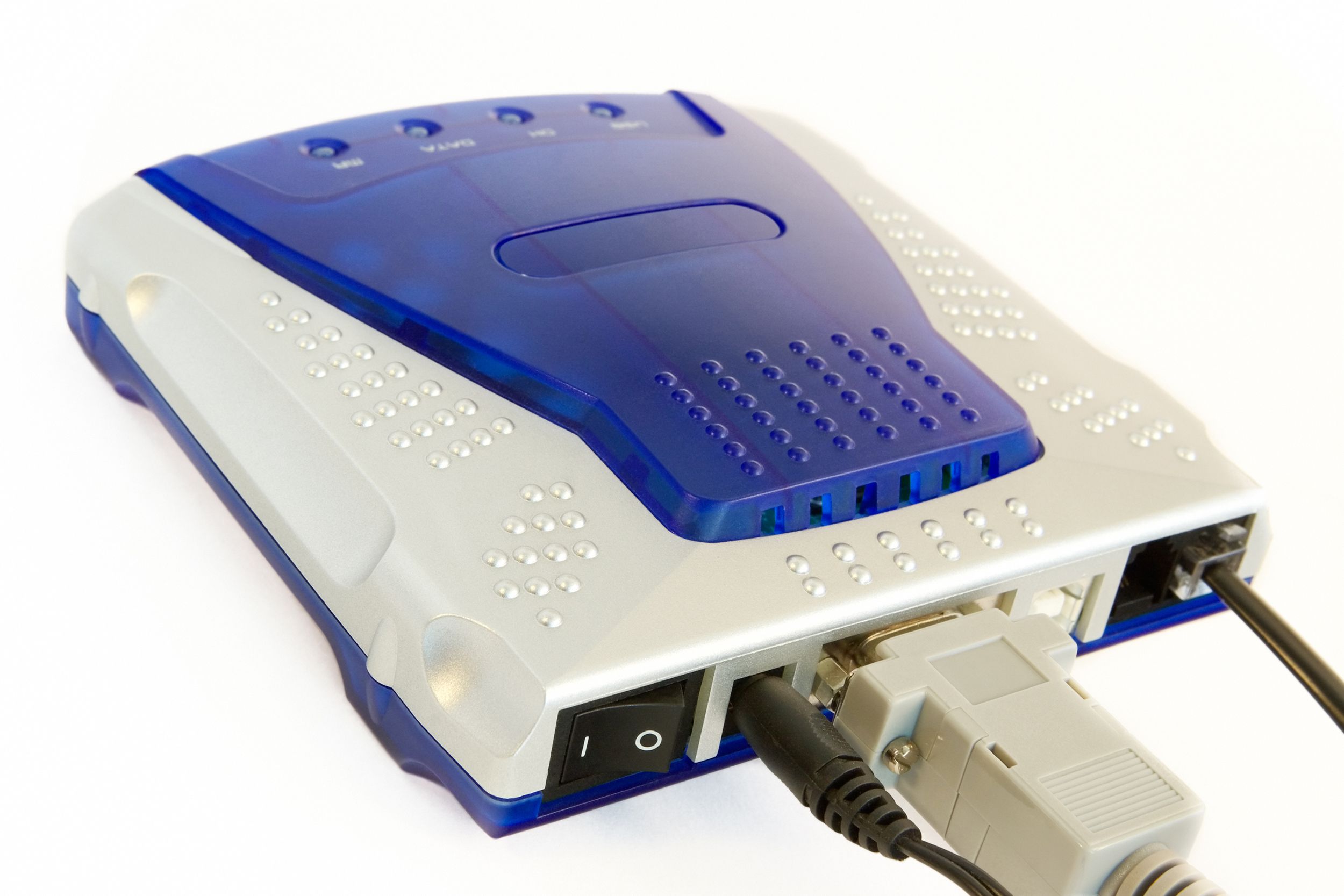 A blue and silver dial-up modem with wires inserted on a white background