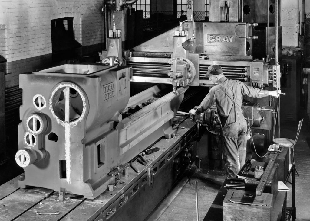 MAN WORKING WITH HEAVY MACHINERY IN MANUFACTURING FACTORY
