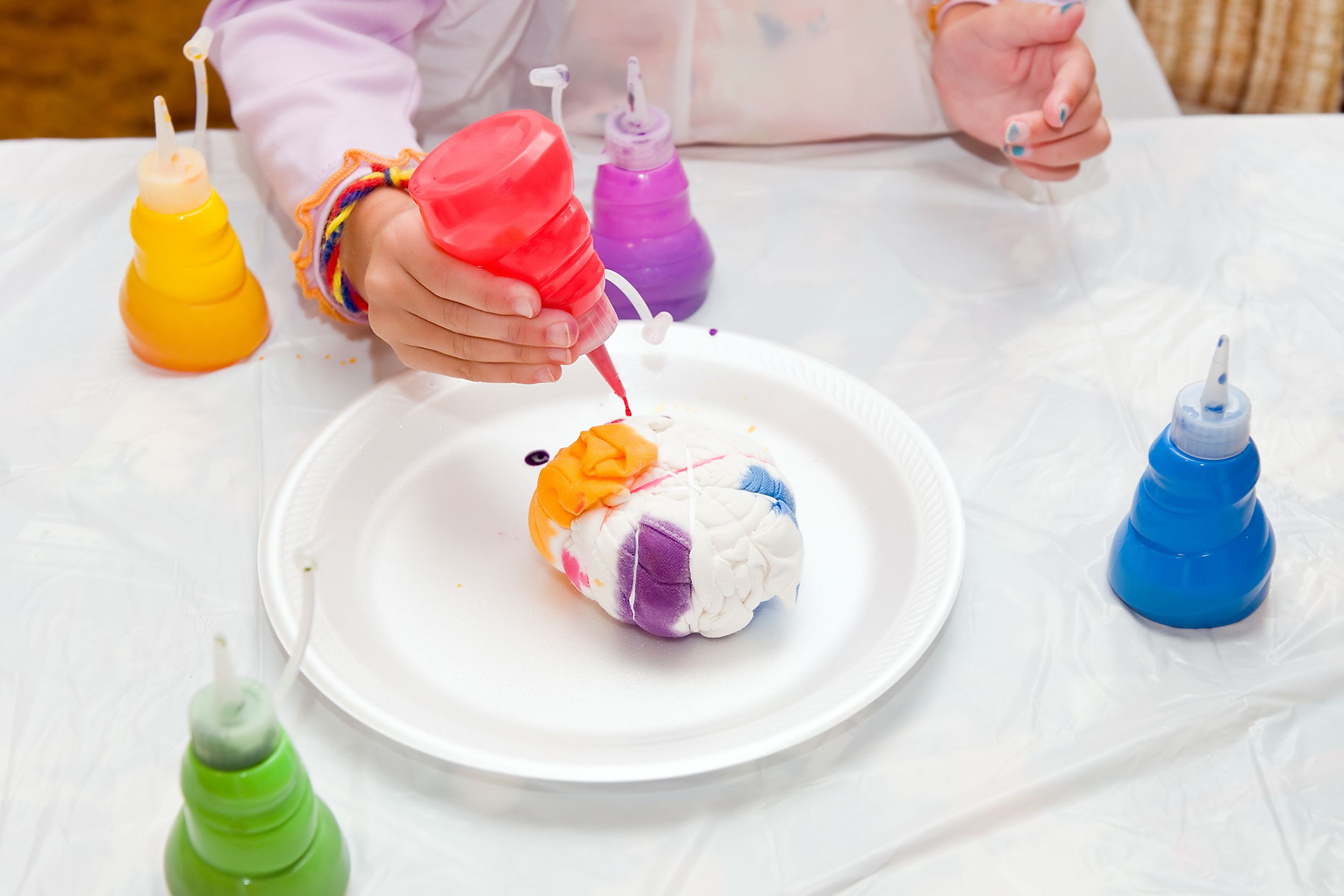 Kid making tie-dye shirts