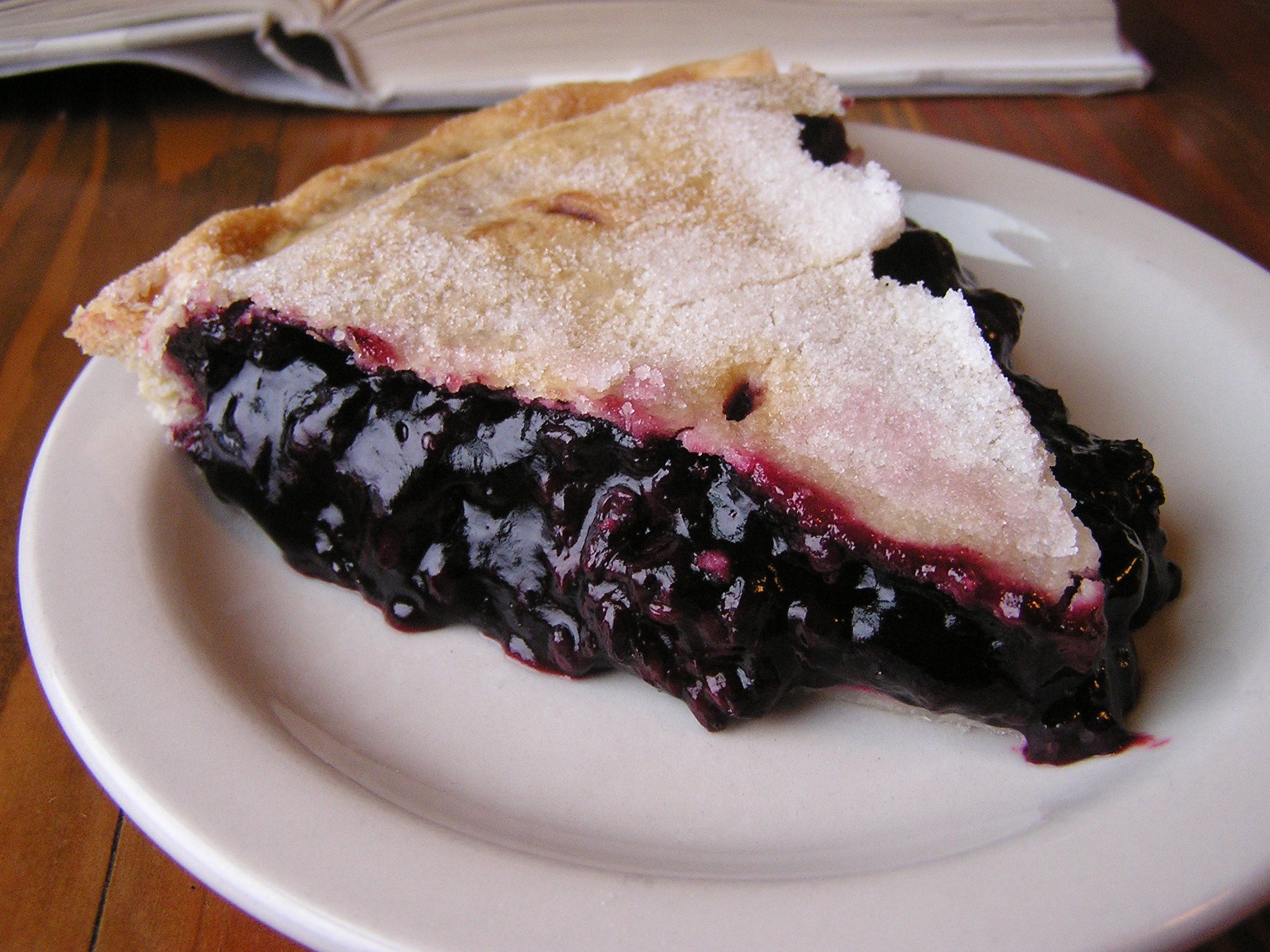 Slice of marionberry pie on a white plate