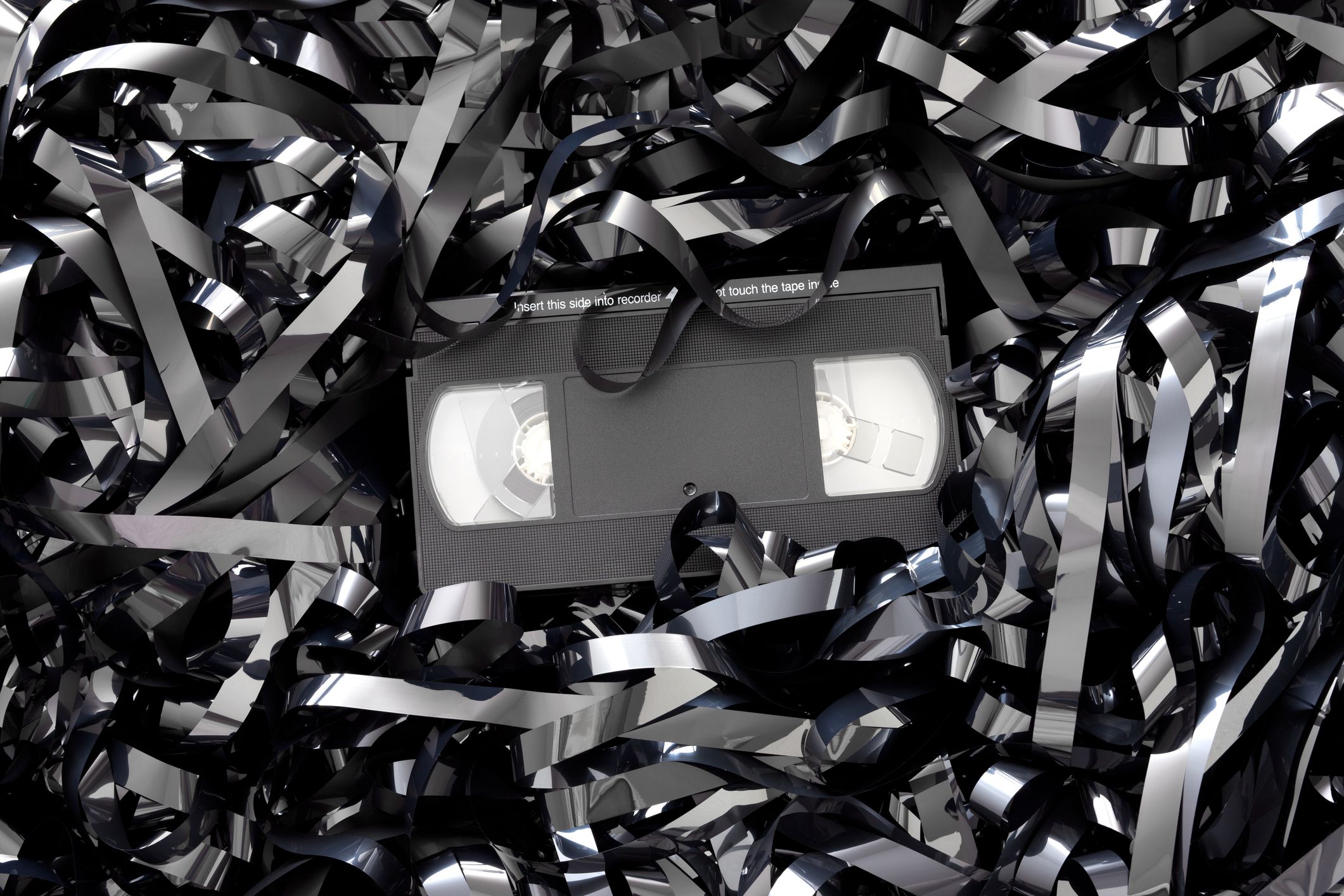 VHS tape laying on lots of VHS magnetic tape