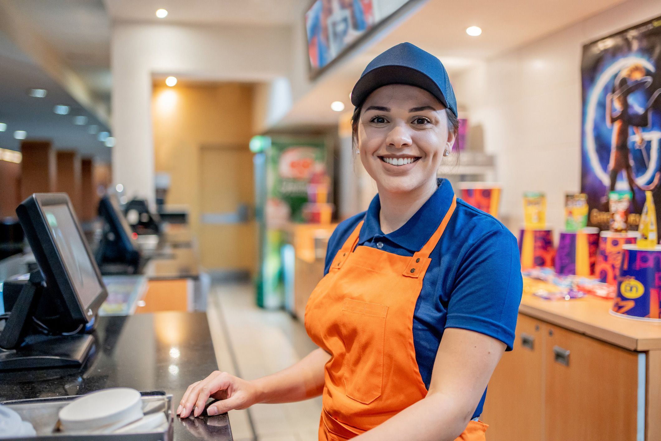 Woman working at a register at a movie theater