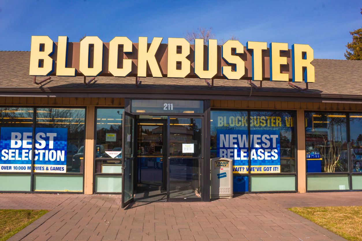 The last Blockbuster store in the USA. The store is shown in the inside and also on the outside from the parking lot.