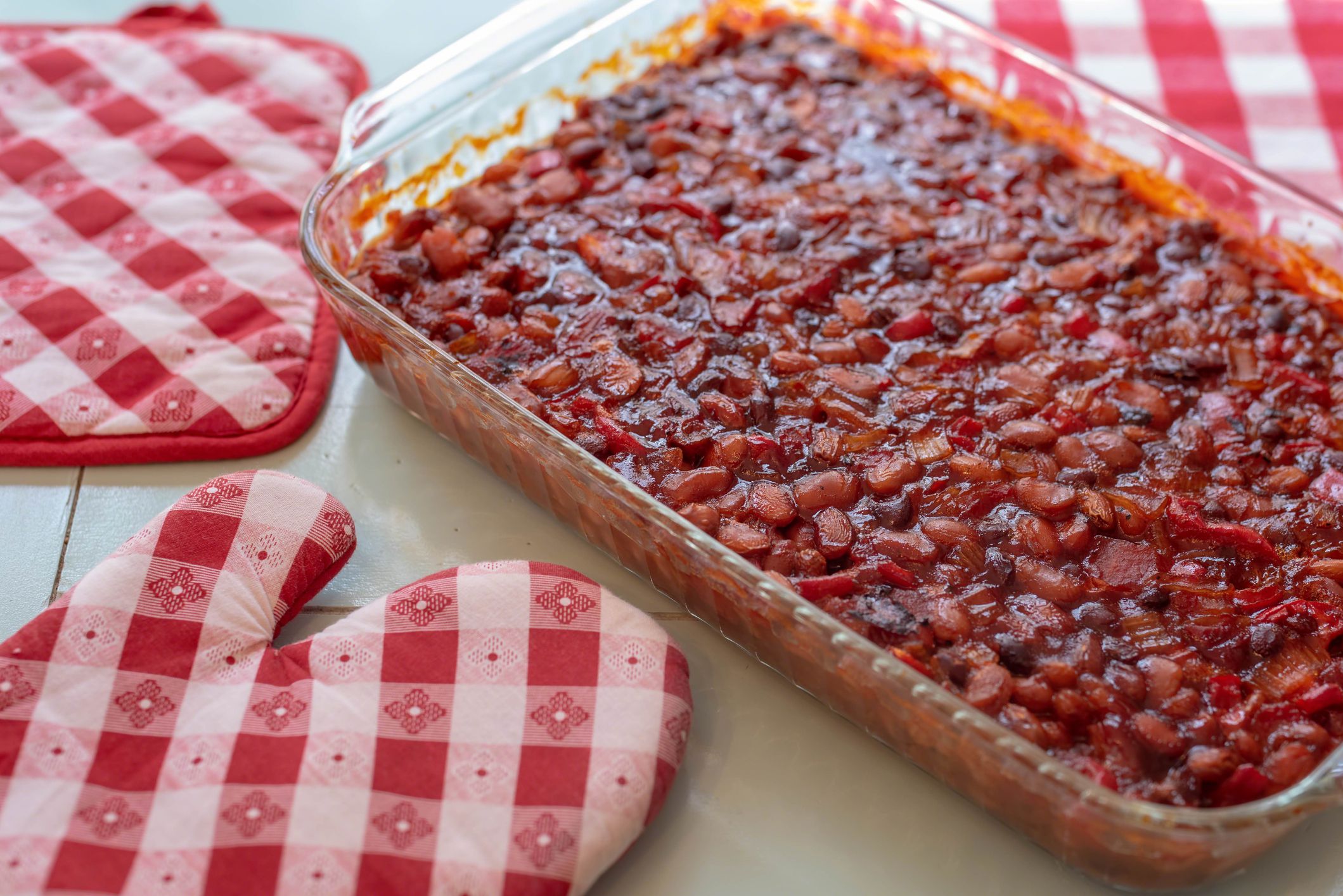 Barbecue baked beans and red checked pot holders - homemade picnic food