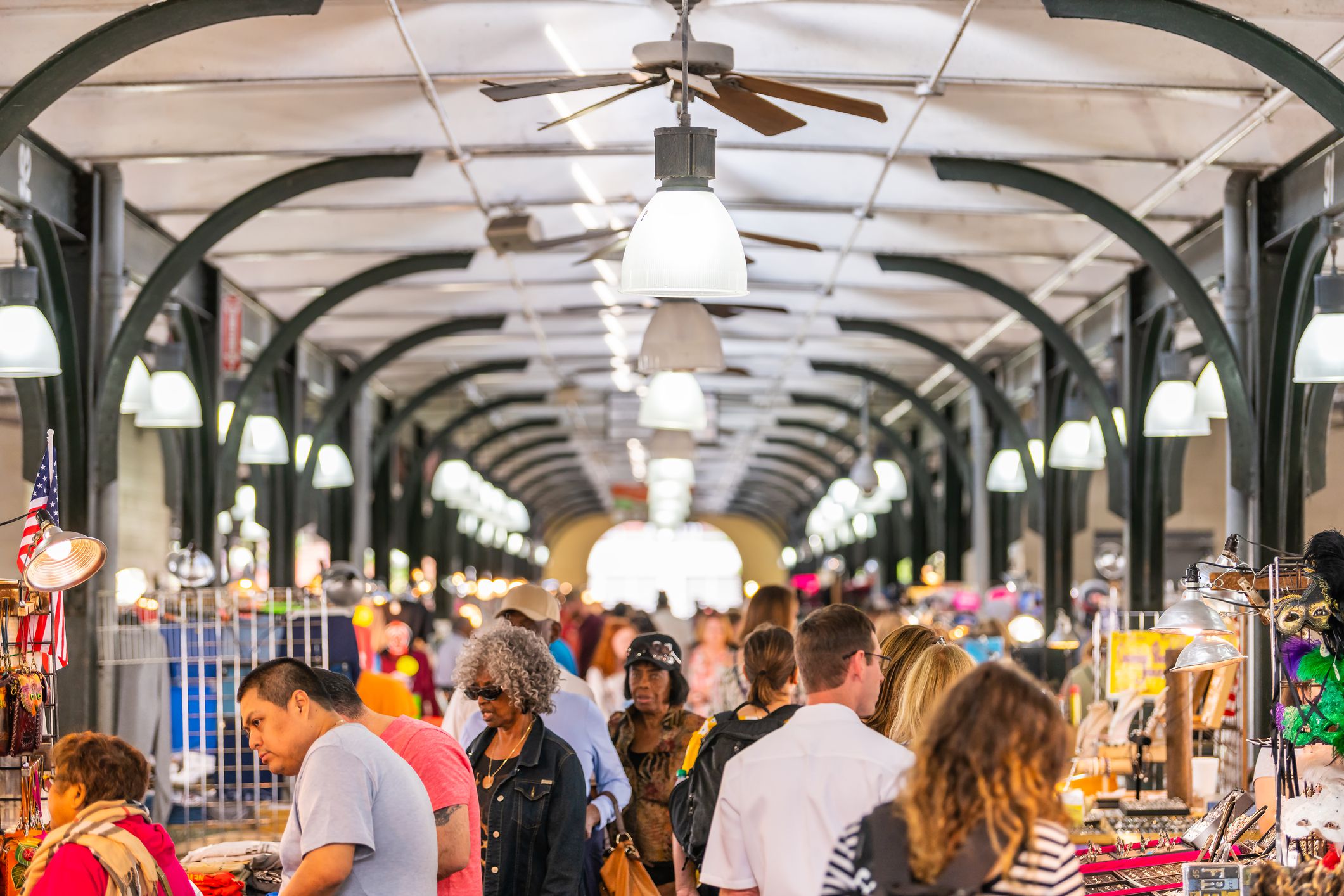 New Orleans, USA - April 23, 2018: Old town French Quarter covered food and flea market inside in Louisiana city and people shopping