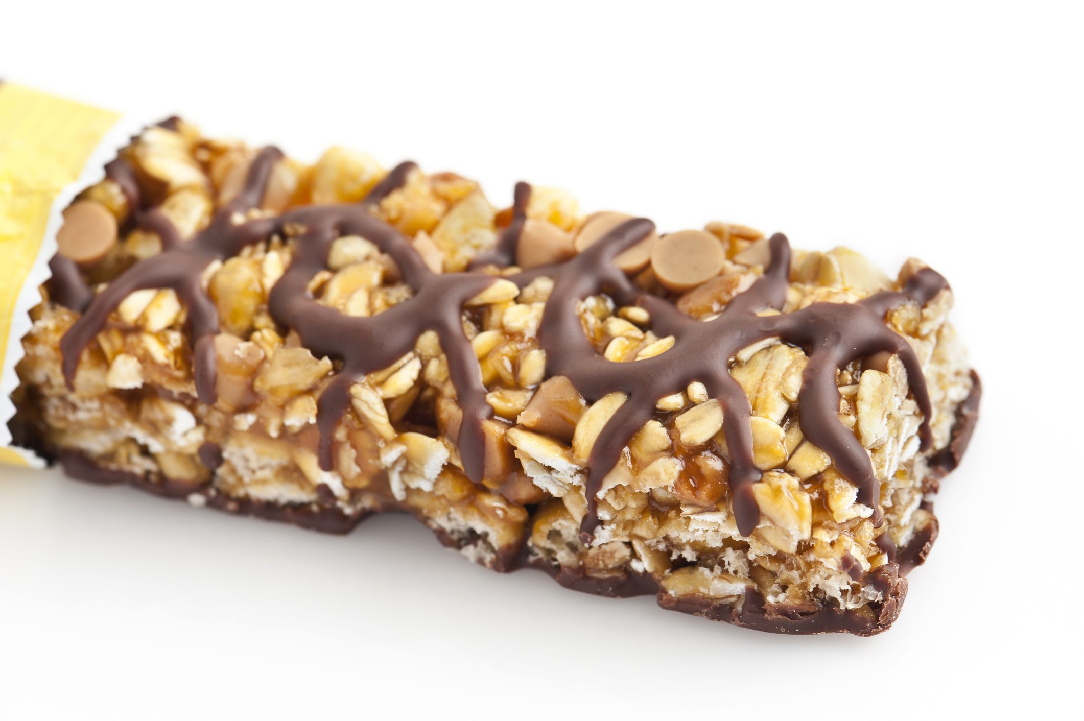 Chocolate and peanut butter energy bar close up on white background