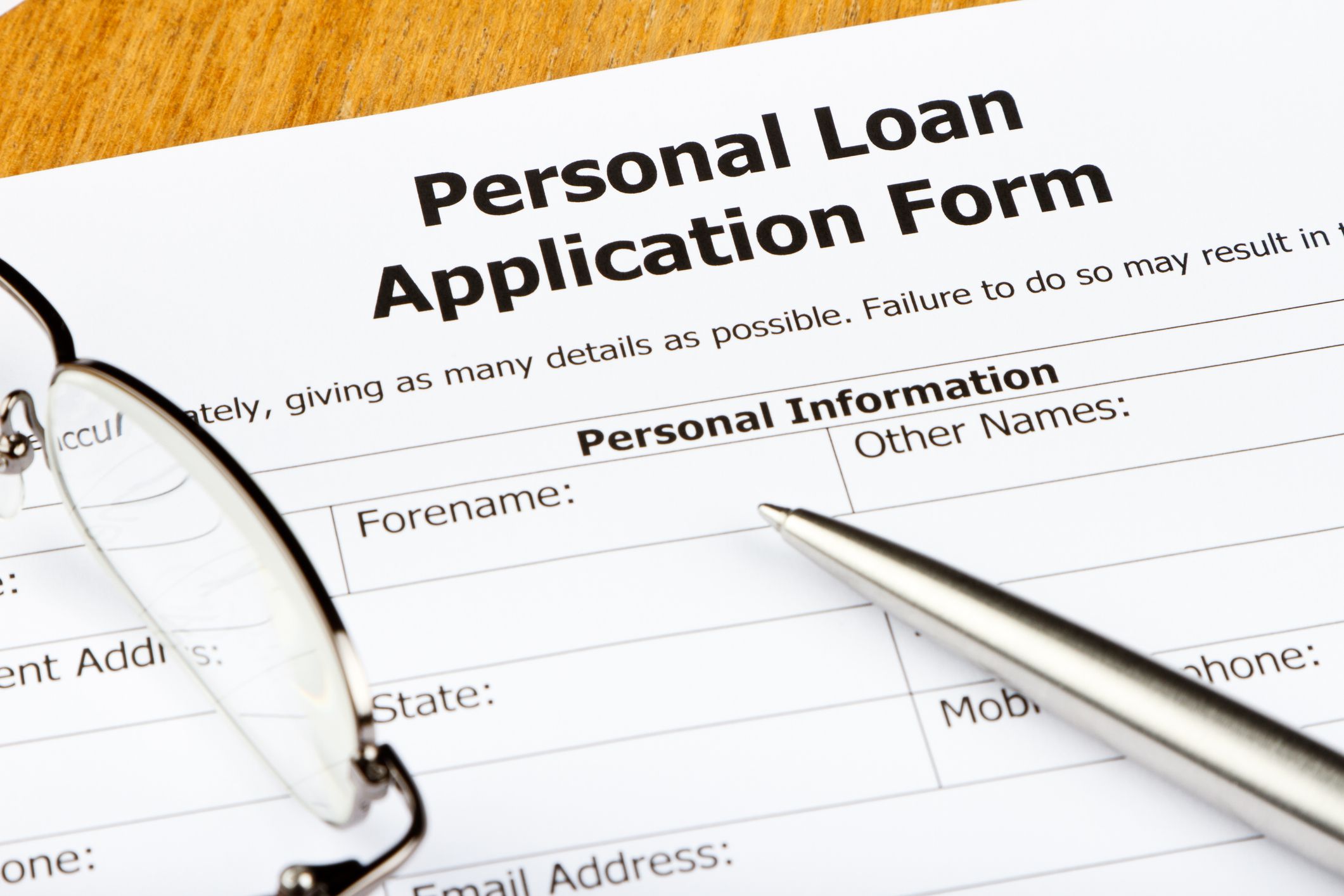 Close-up of a Personal Loan application with Spectacles and pen.
