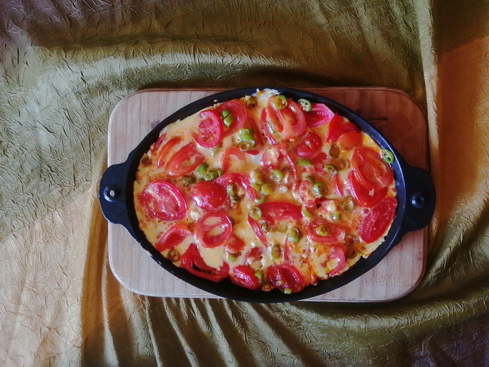 A Turkish delicacy, menemen, tomatoes, peppers, onions, eggs, fried copper, on wood - Sahanda Menemen