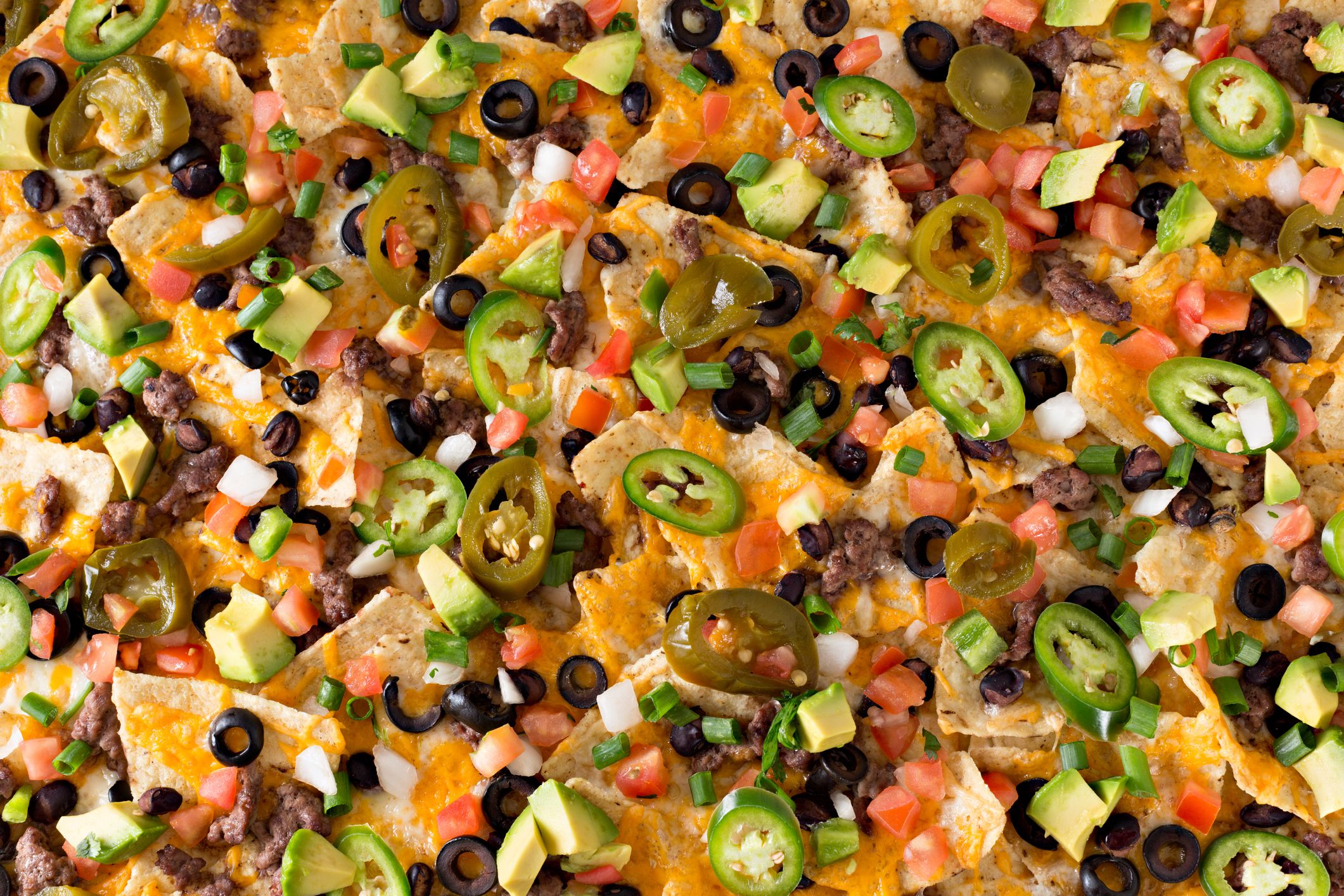 An overhead close up horizontal photograph of some spicy Cinco De Mayo nachos.