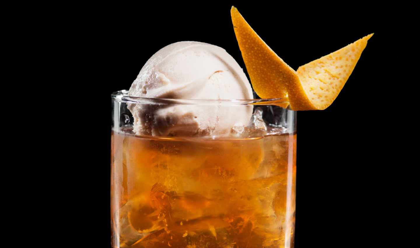 Cocktail Drink. Rum, Ice cream, Orange. Black Background.