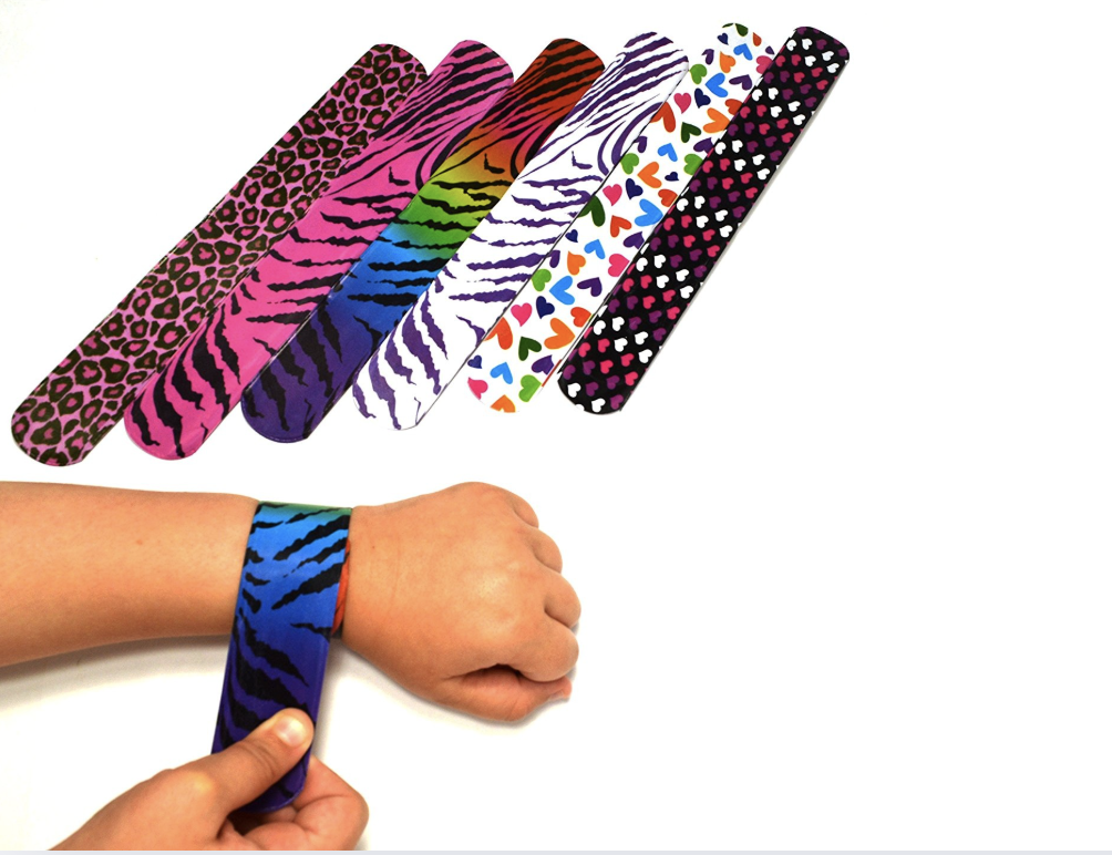 Assorted slap bracelets next to a wrist with a slap bracelet