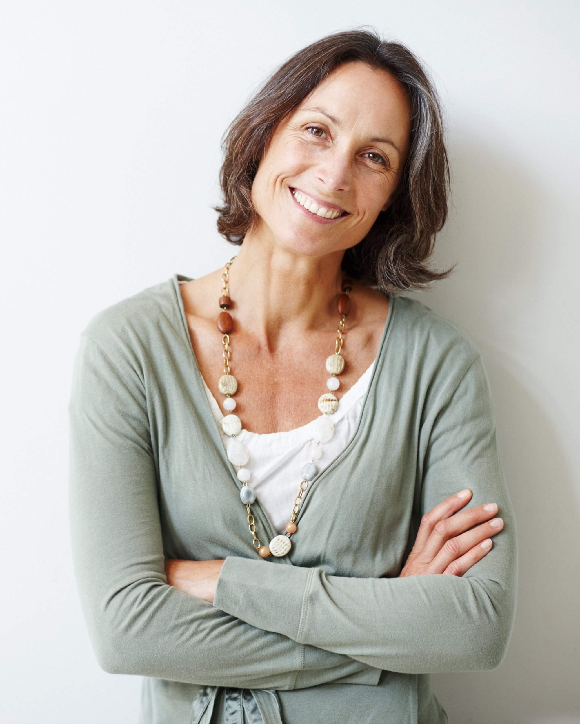 elegant middle aged woman with her arms crossed