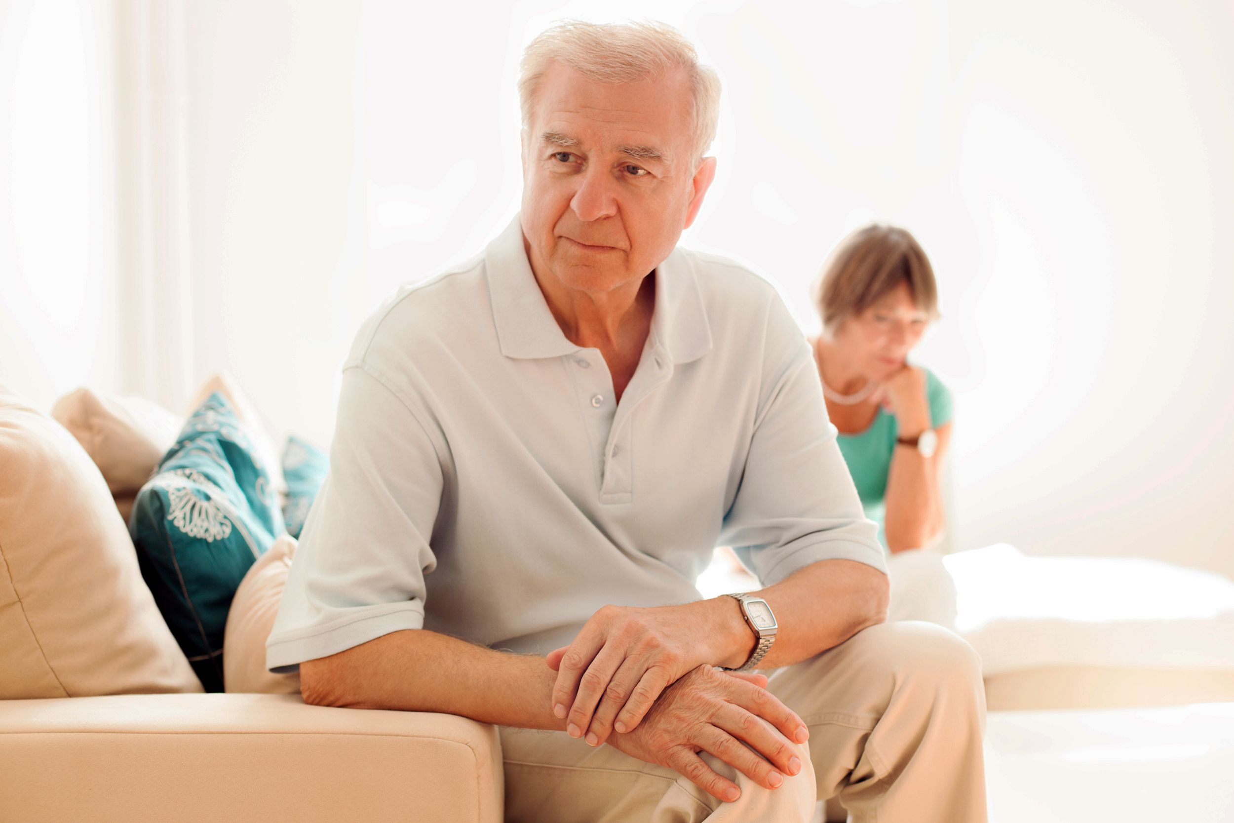 senior man upset while wife watches