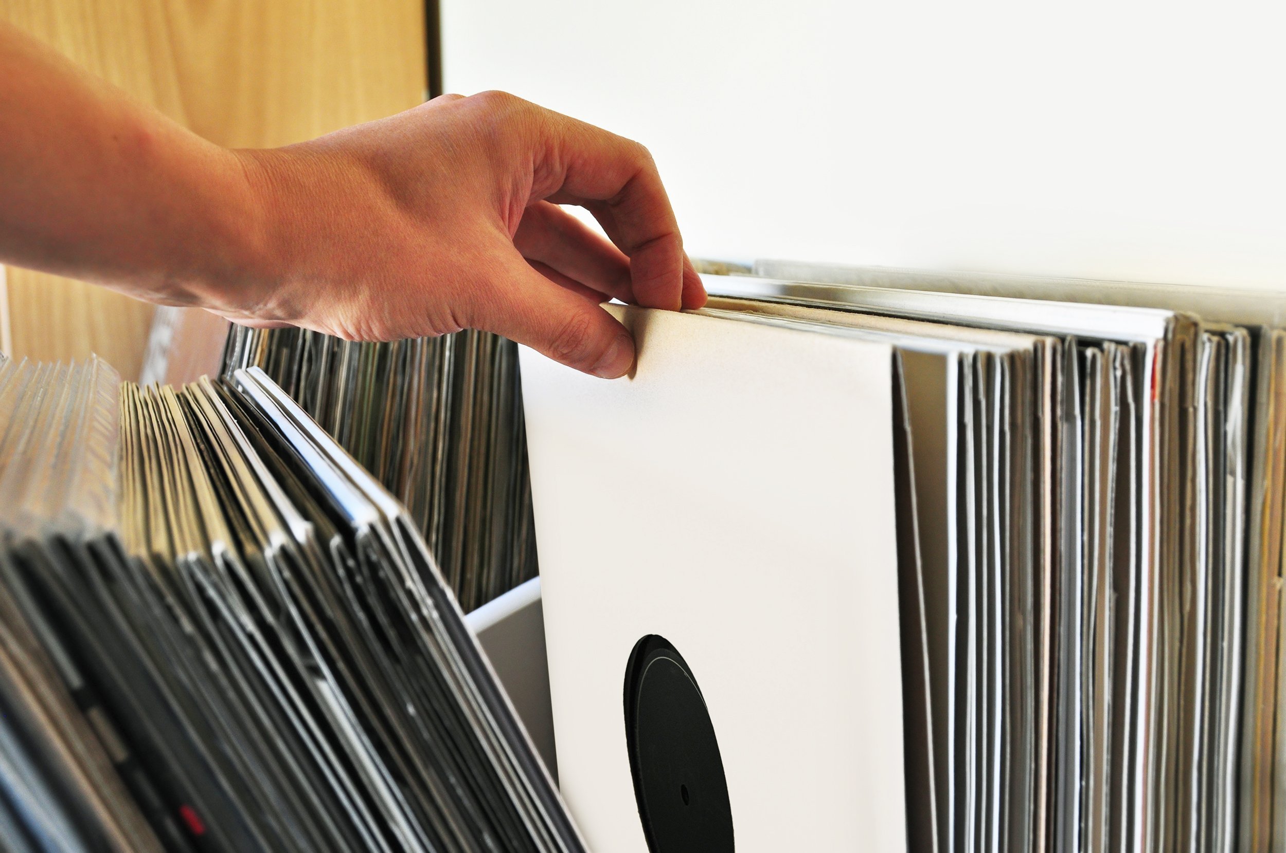 browsing through vinyl records collection